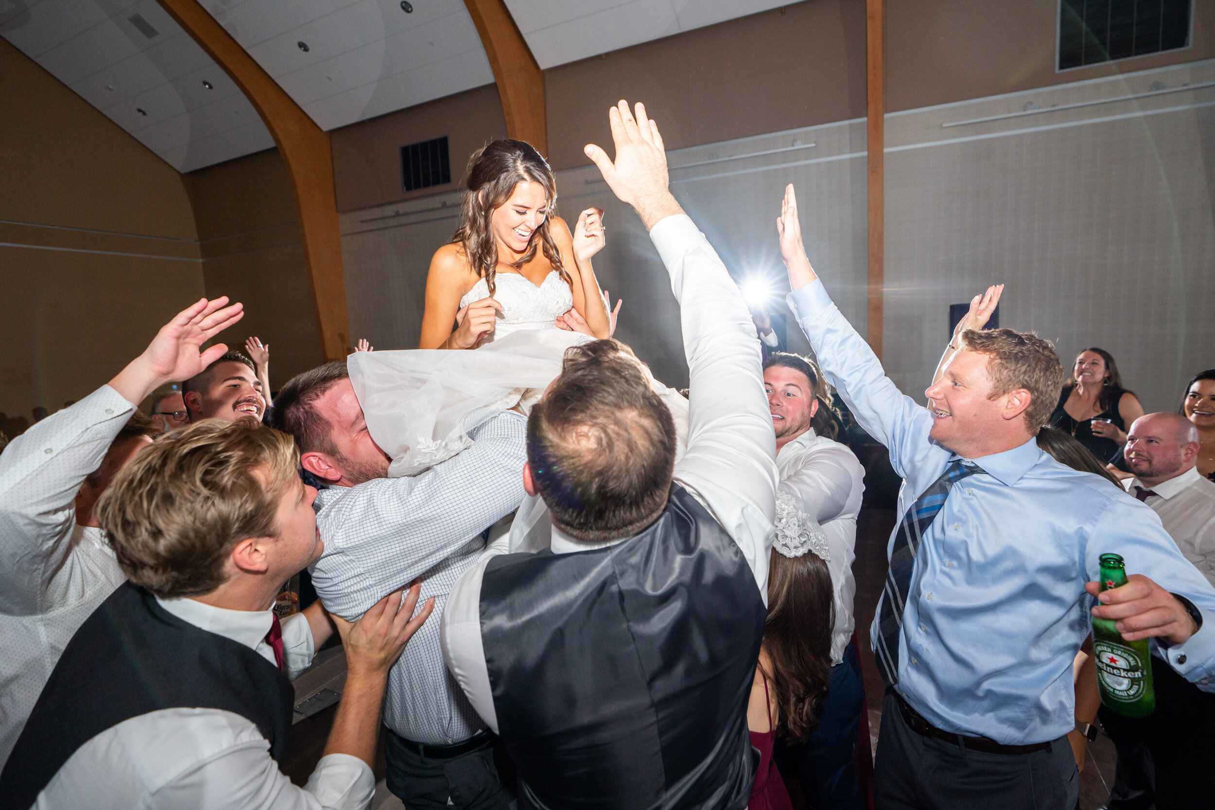 Bride being tossed in the air by groomsmen at Riverview at Occoquan