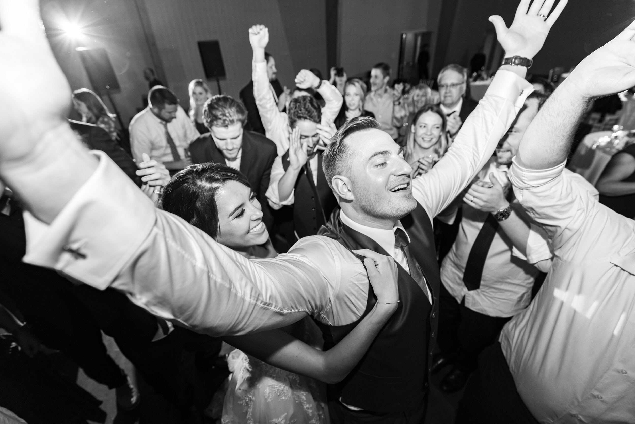 Bride clutching groom in the middle of the dance floor during last song