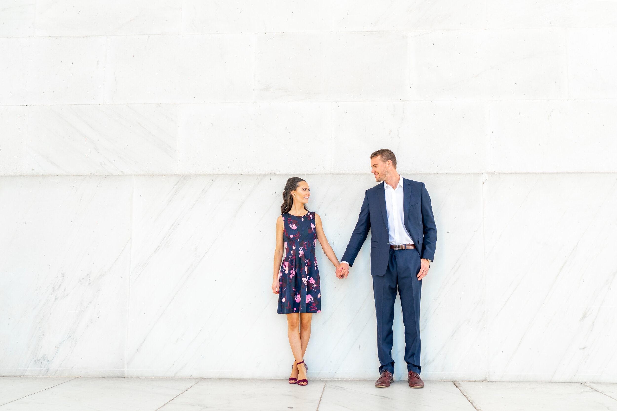 Engagement photos at the lincoln memorial couple leaning against wall