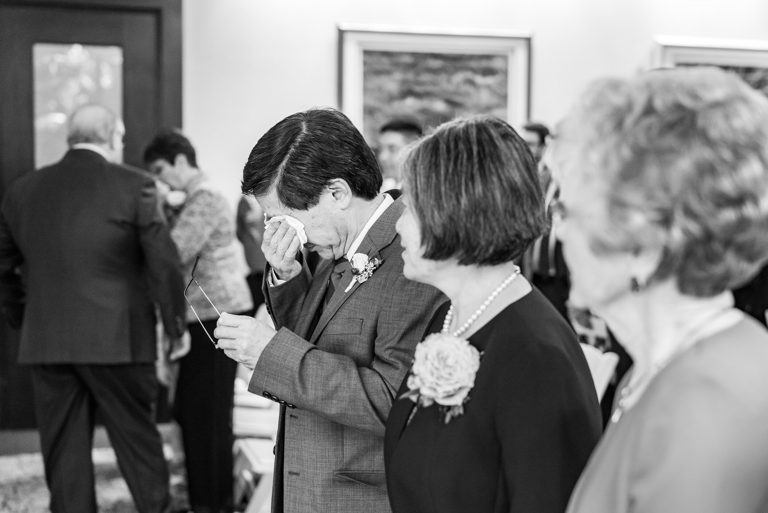Father of the bride crying during ceremony in koi room at 2941