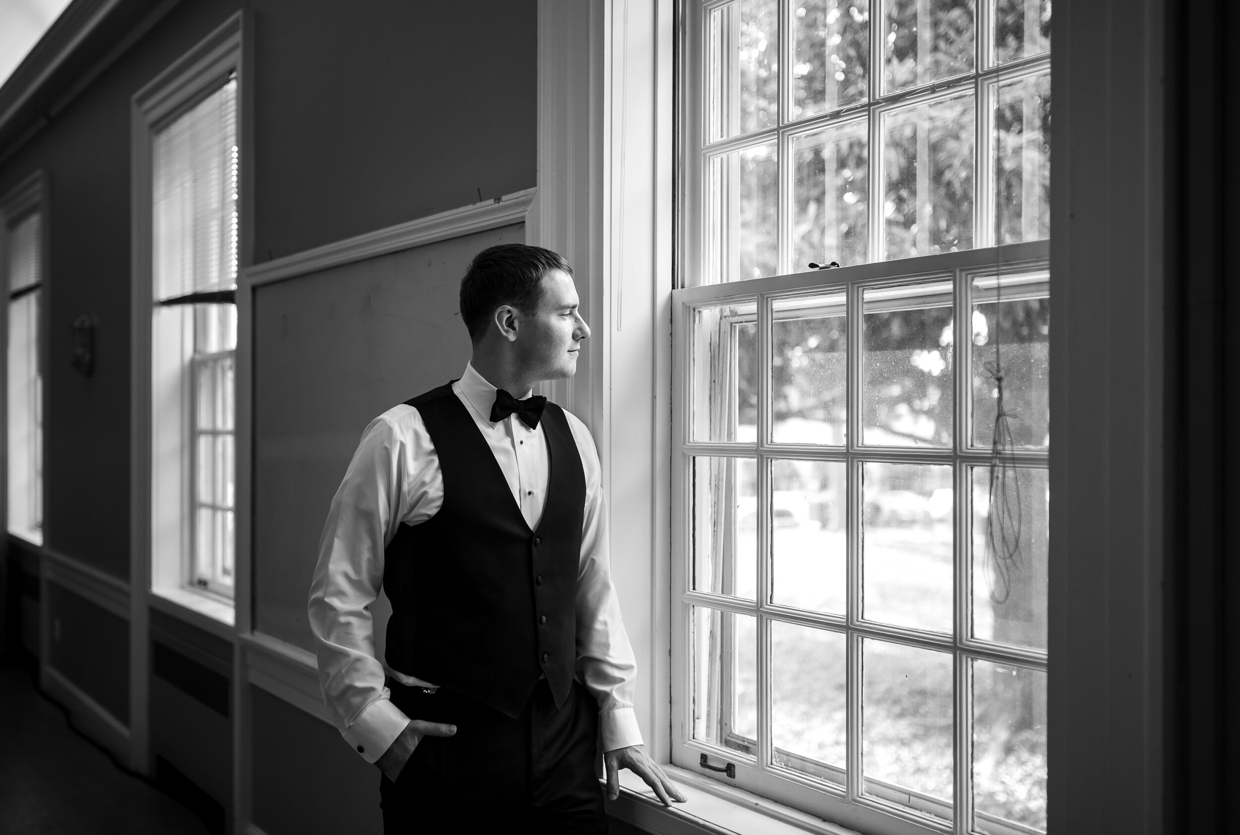 groom in window at falls church episcopal upstairs