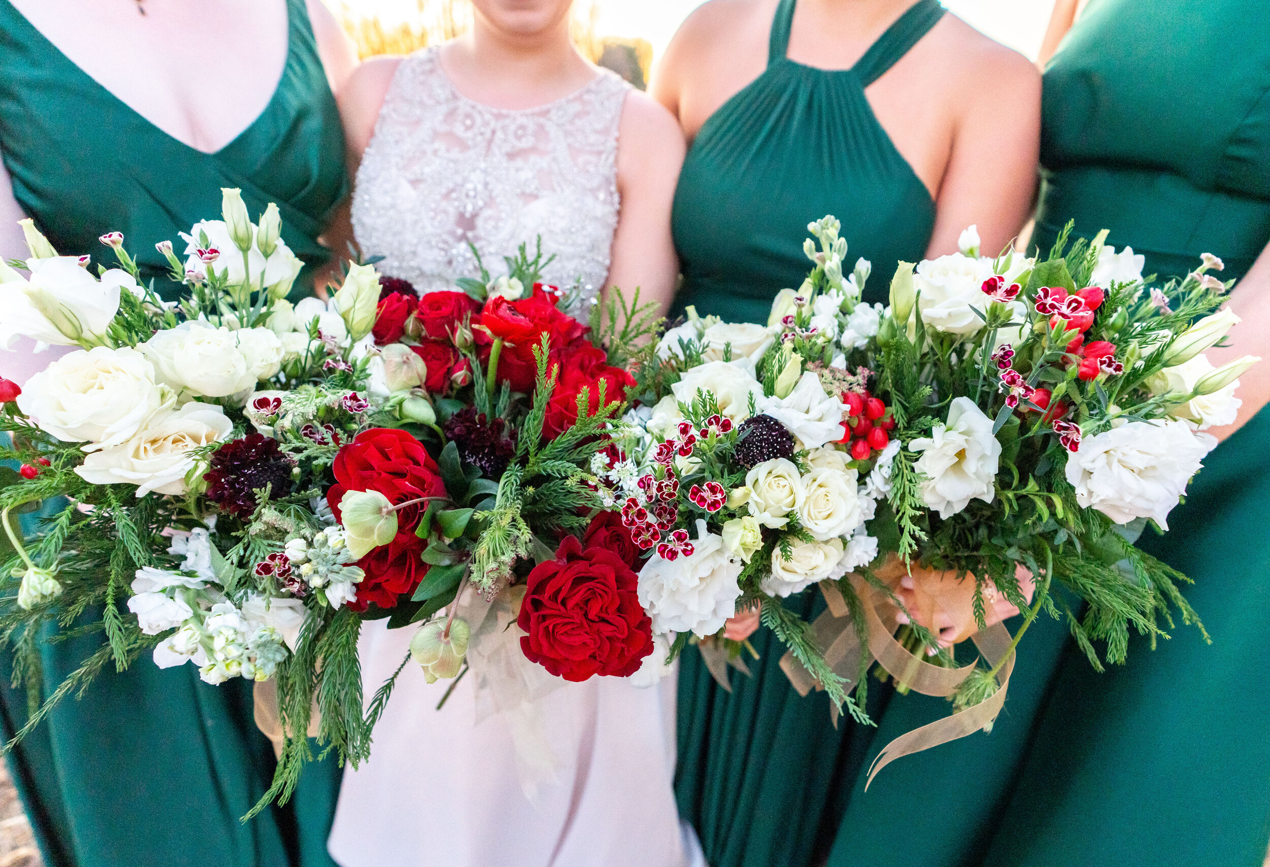 christmas bride and bridesmaids bouquet with emerald gowns