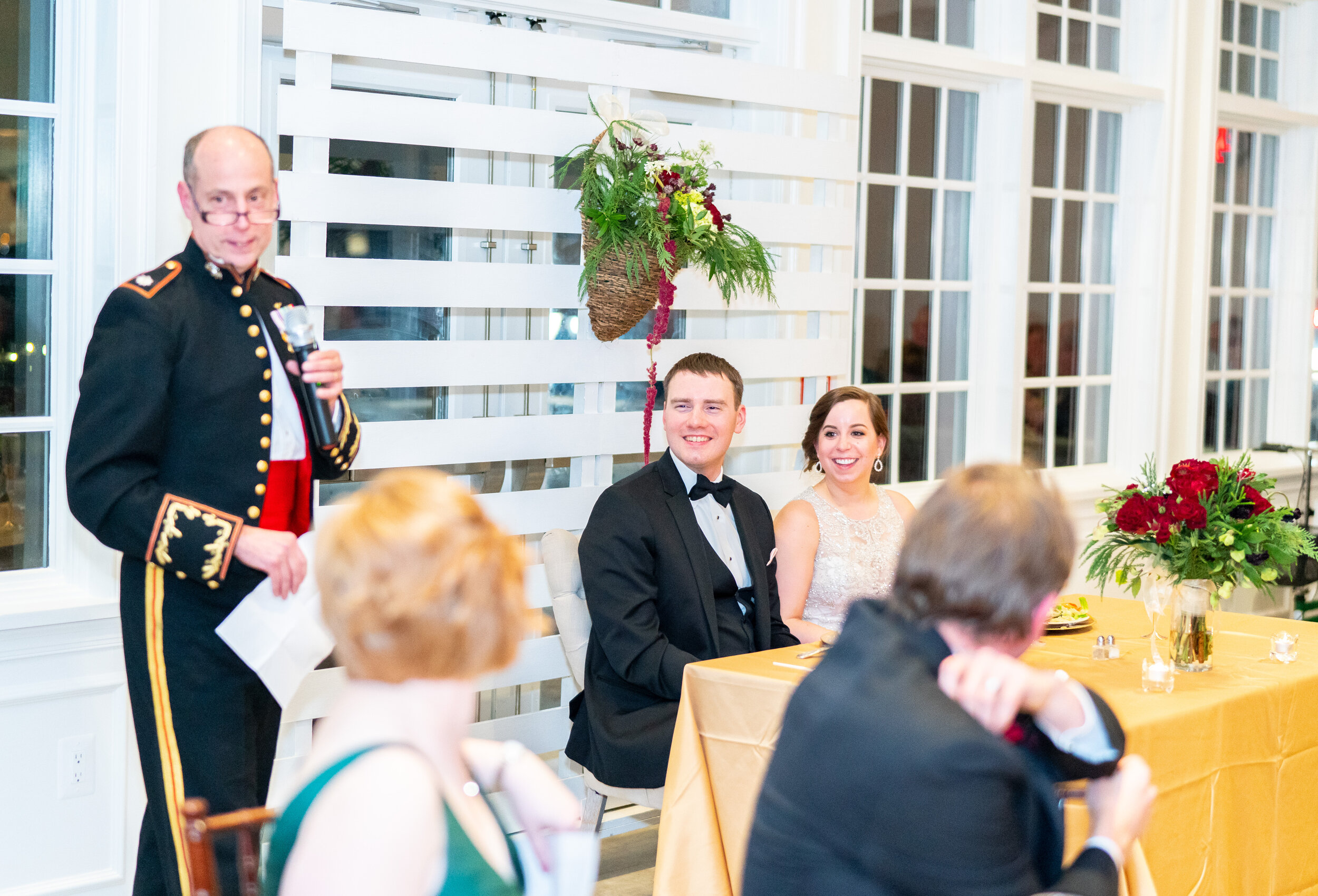 Military father of the bride gives toast during dinner at Ospreys