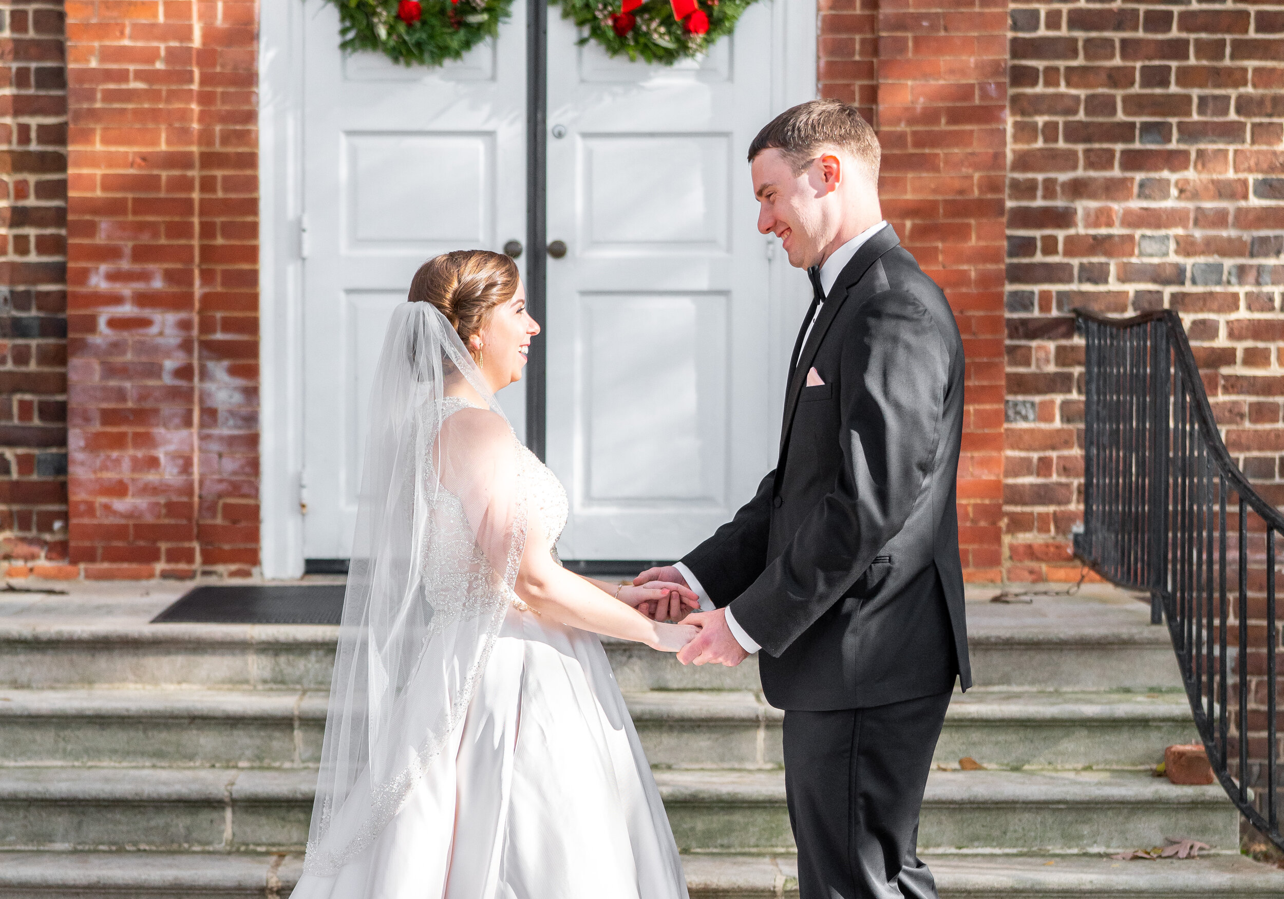 bride and groom first look at front doors of the falls church episcopal wedding