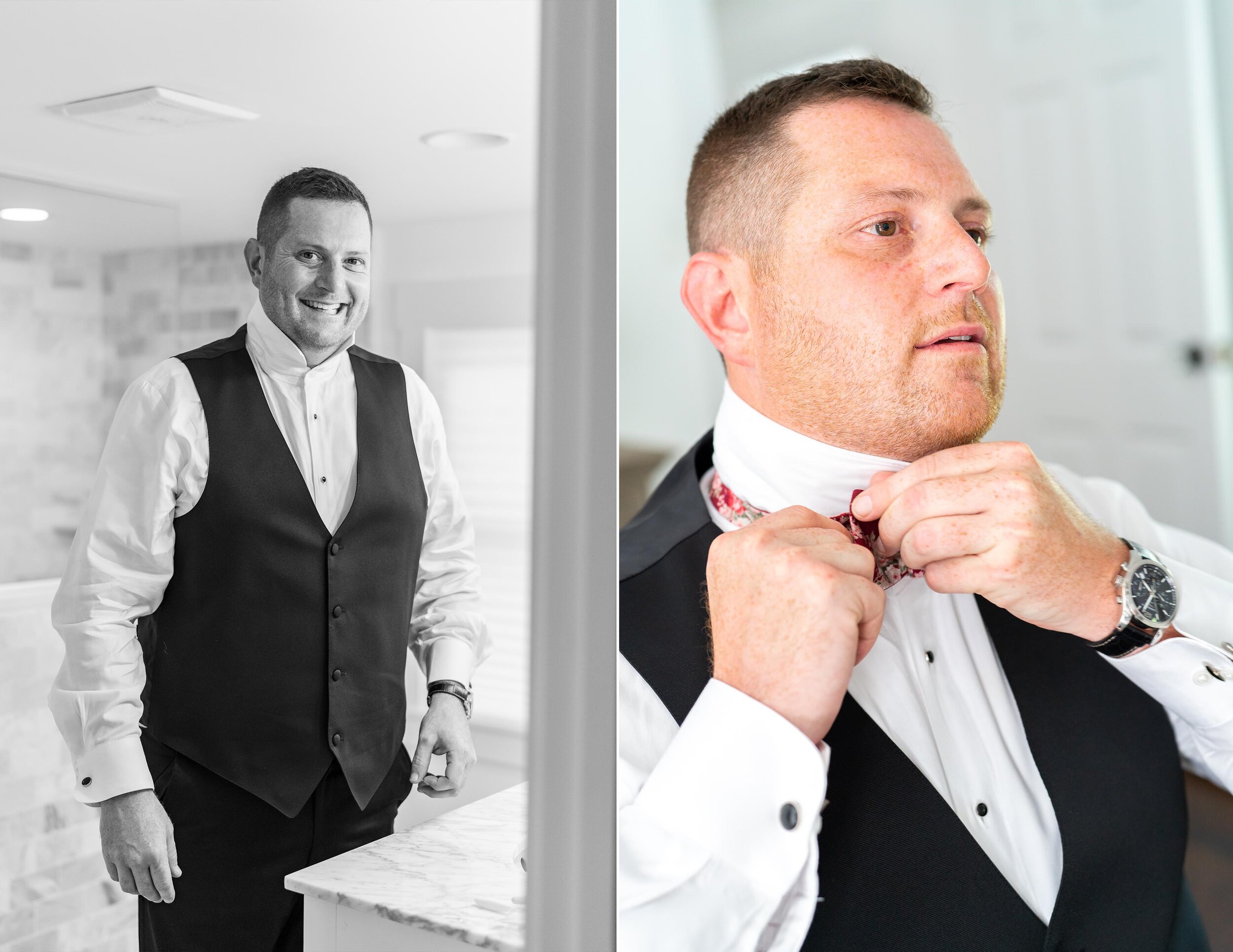 Groom putting on his bow tie and looking in a mirror 