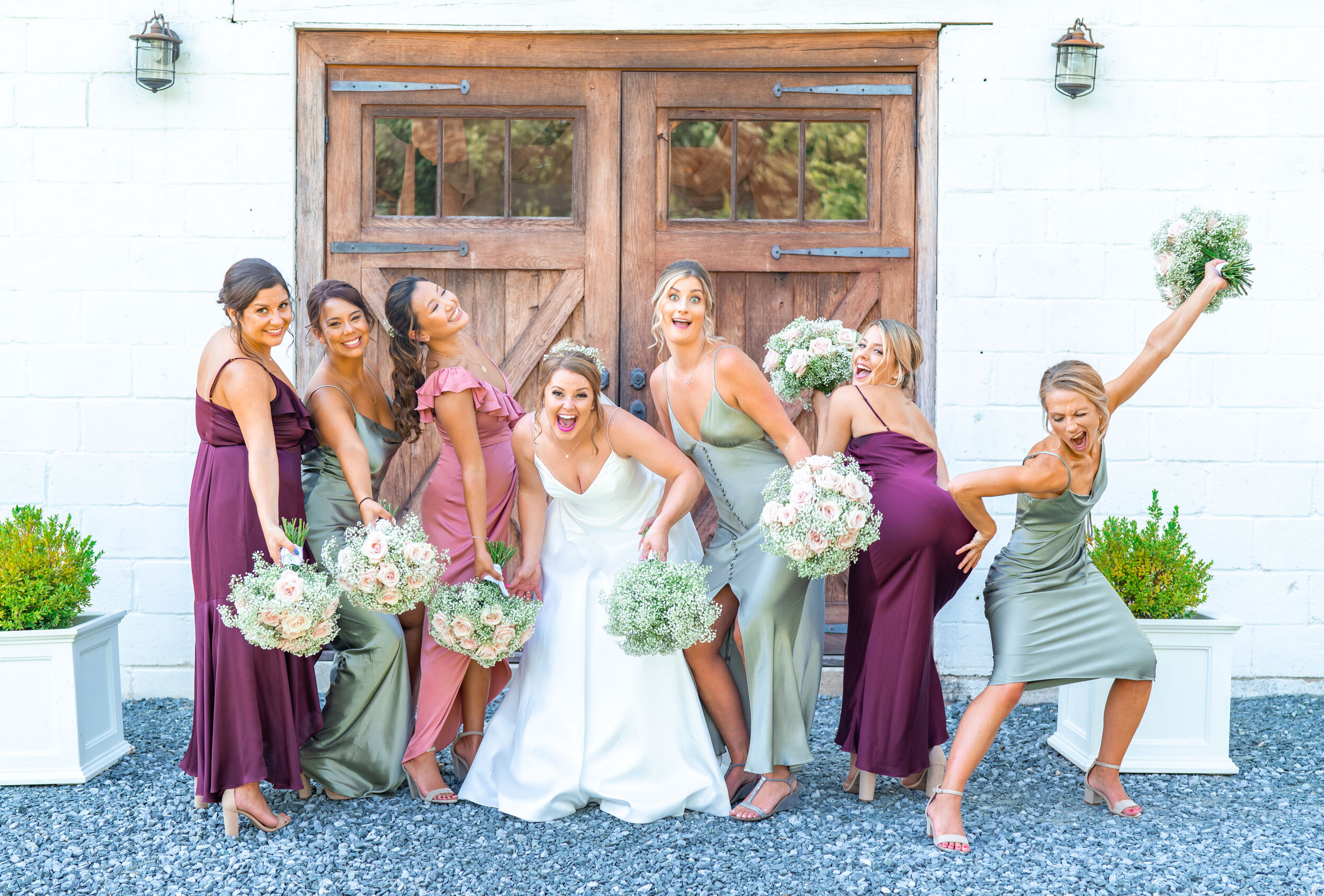 Bridesmaids being silly with rose, burgundy and sage Shona Joy dresses and baby's breath bouquets