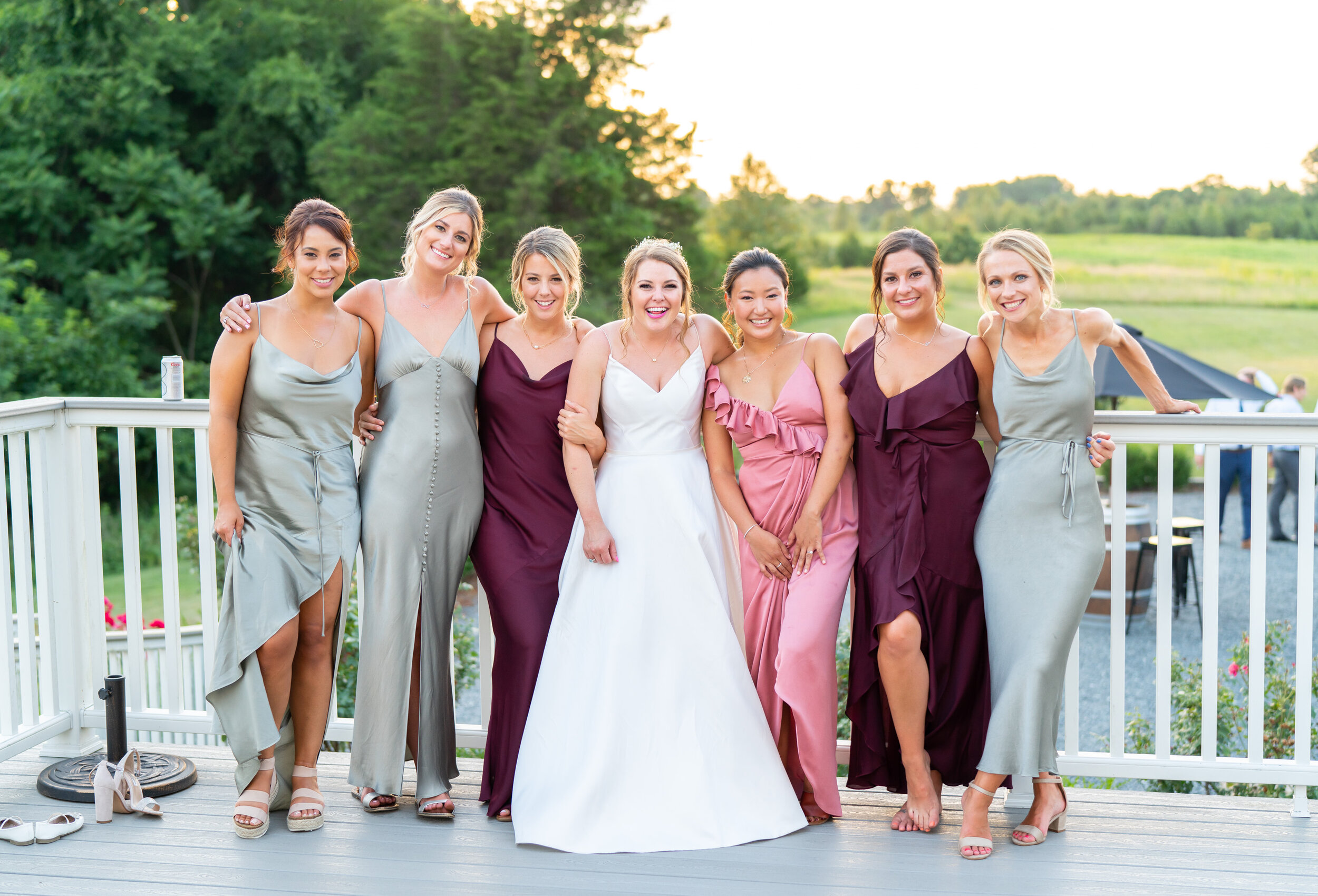 Bride and bridesmaids in mix and match Shona Joy dresses in rose, sage and burgundy
