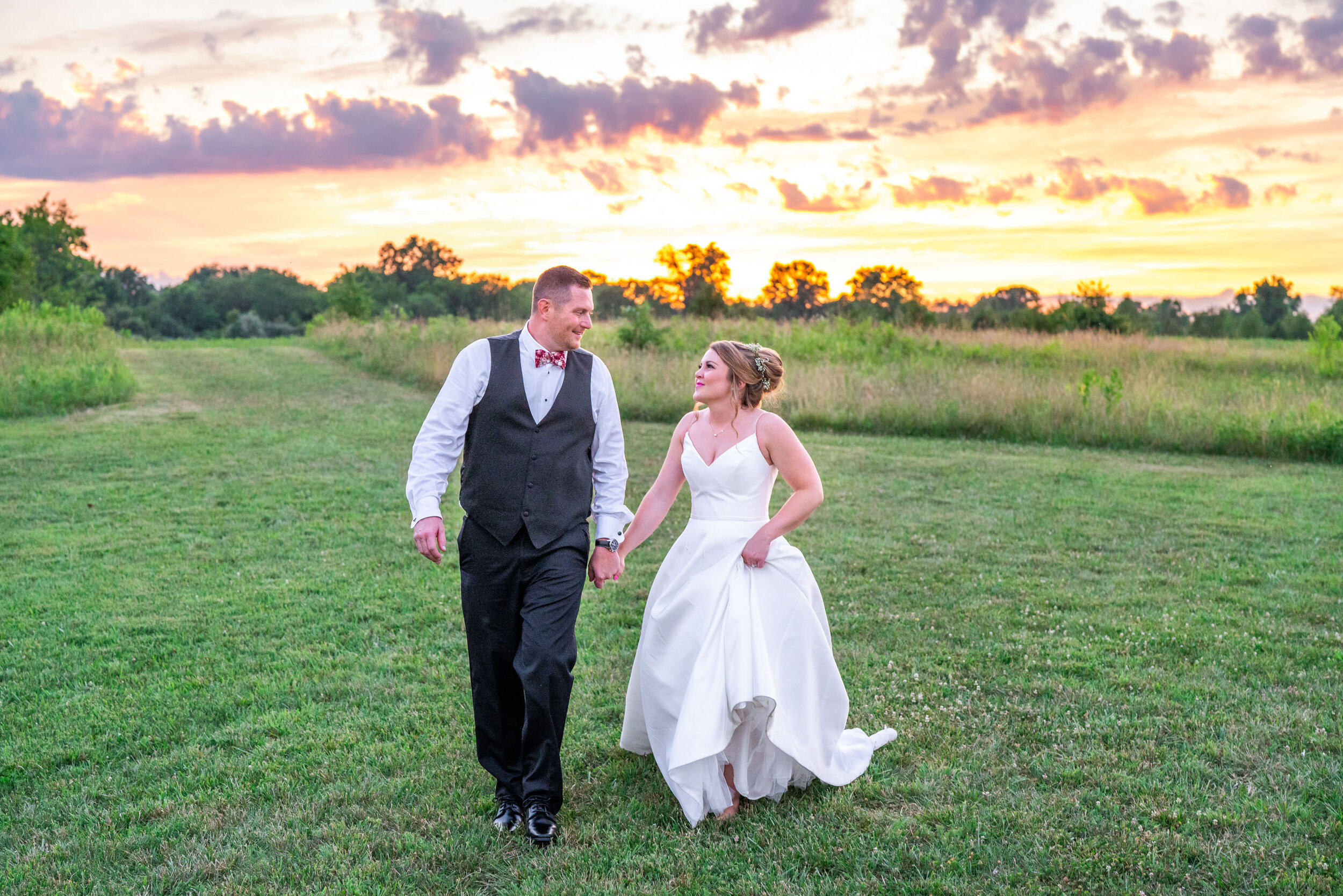 Bride and groom walk in the sunset at 48 Fields