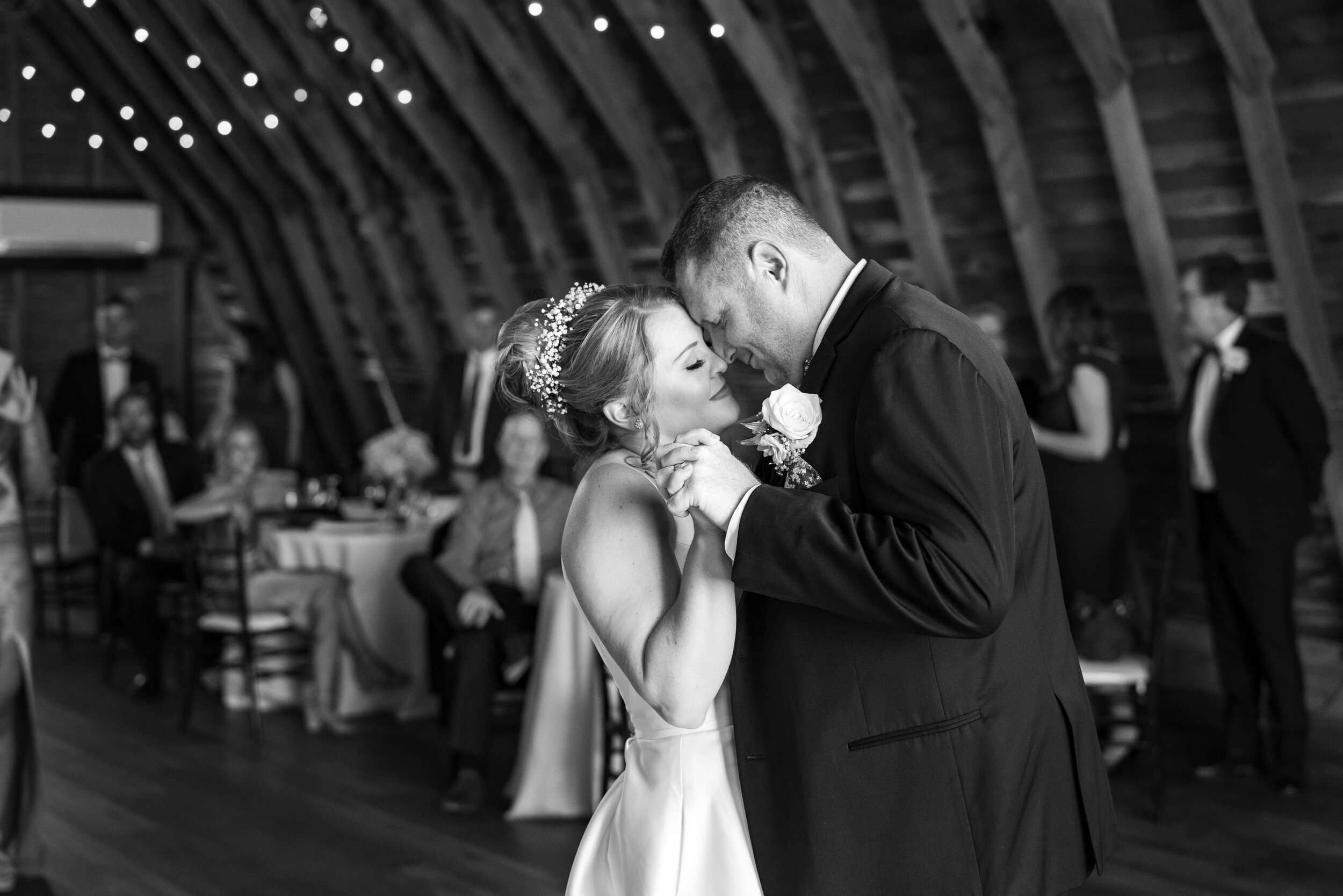 Bride and groom first dance in black and white upstairs in the barn at 48 Fields 