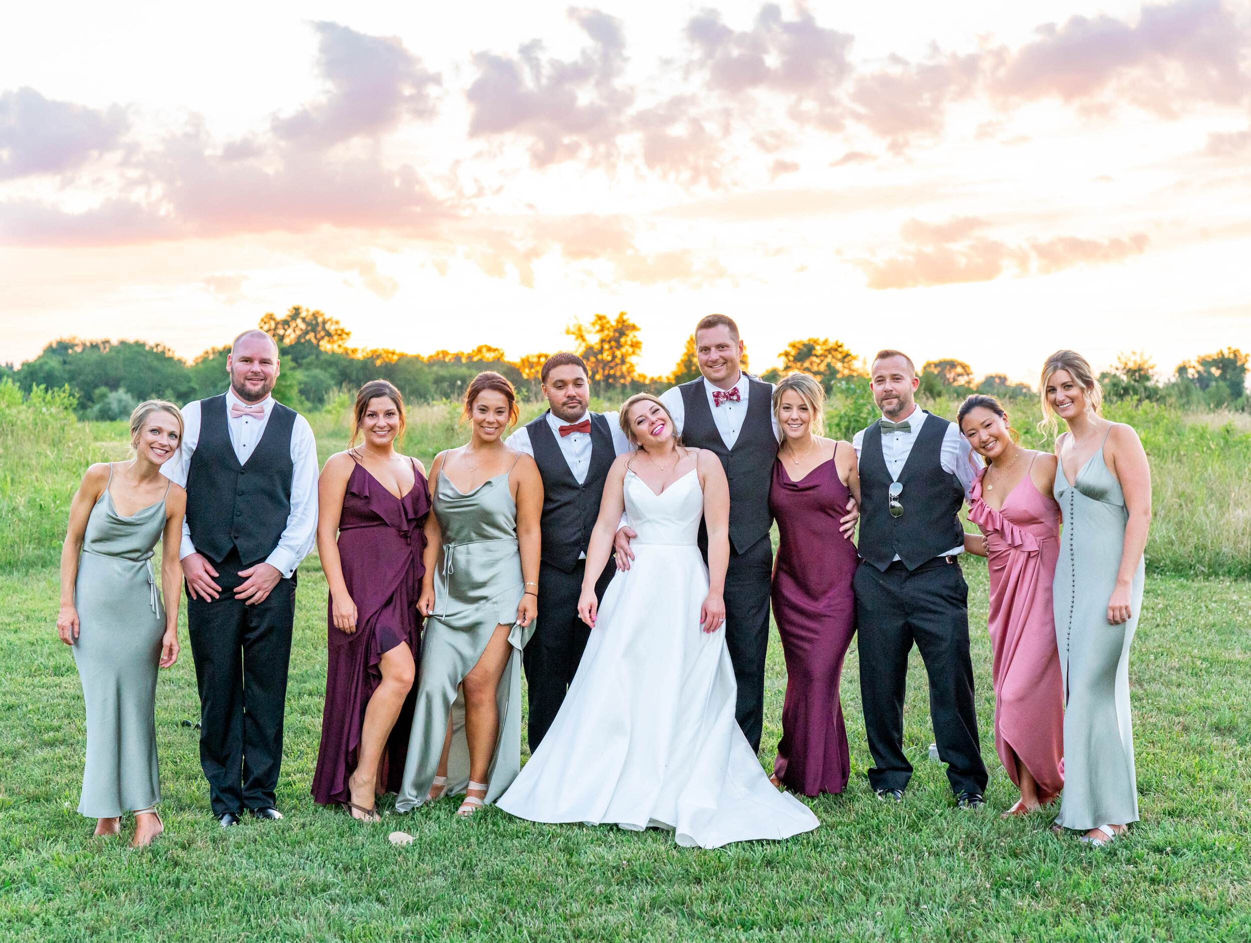 Entire bridal party during sunset in Shona Joy dresses in sage, rose and burgundy