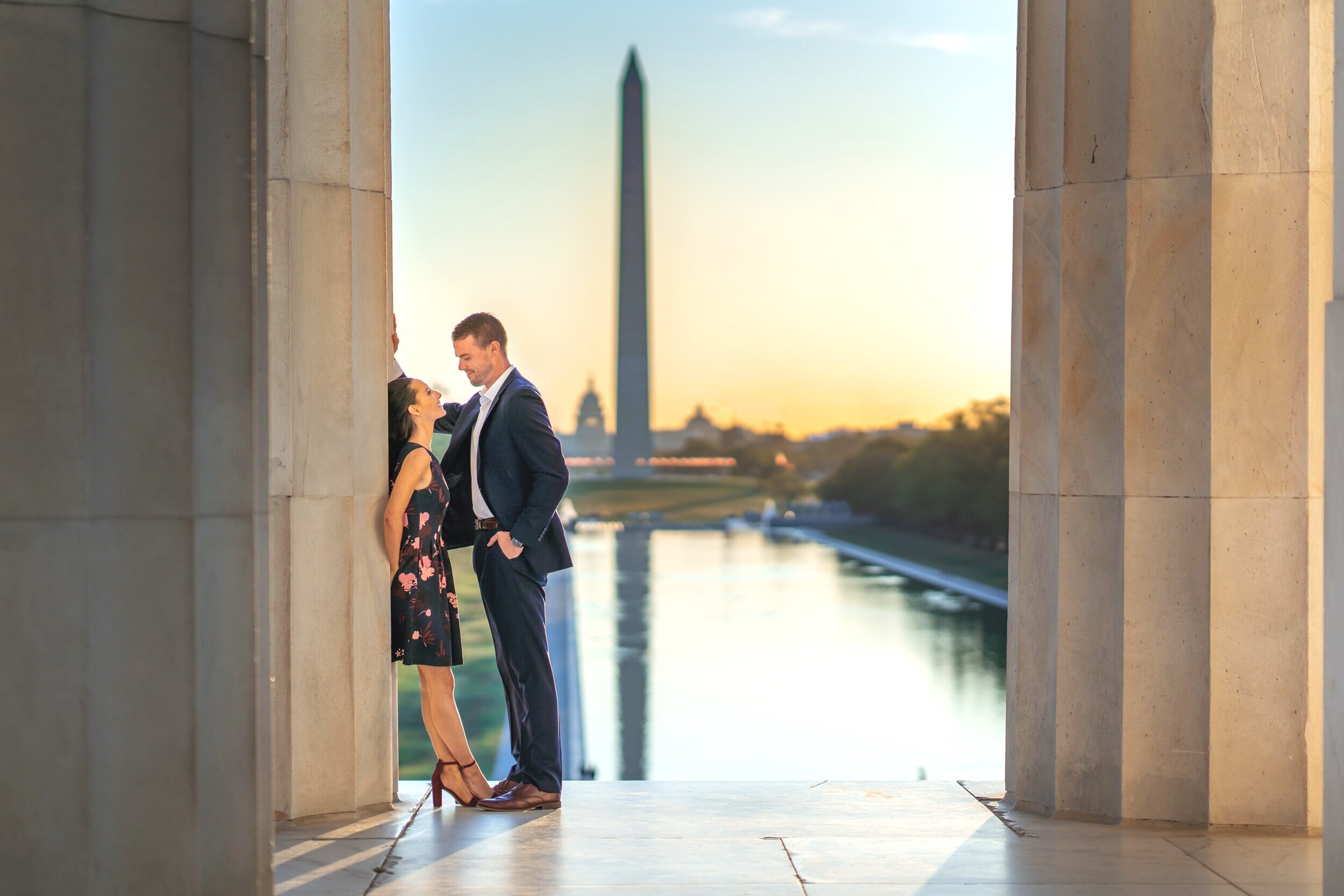 Sunrise engagement photo at the lincoln memorial overlooking the national monument