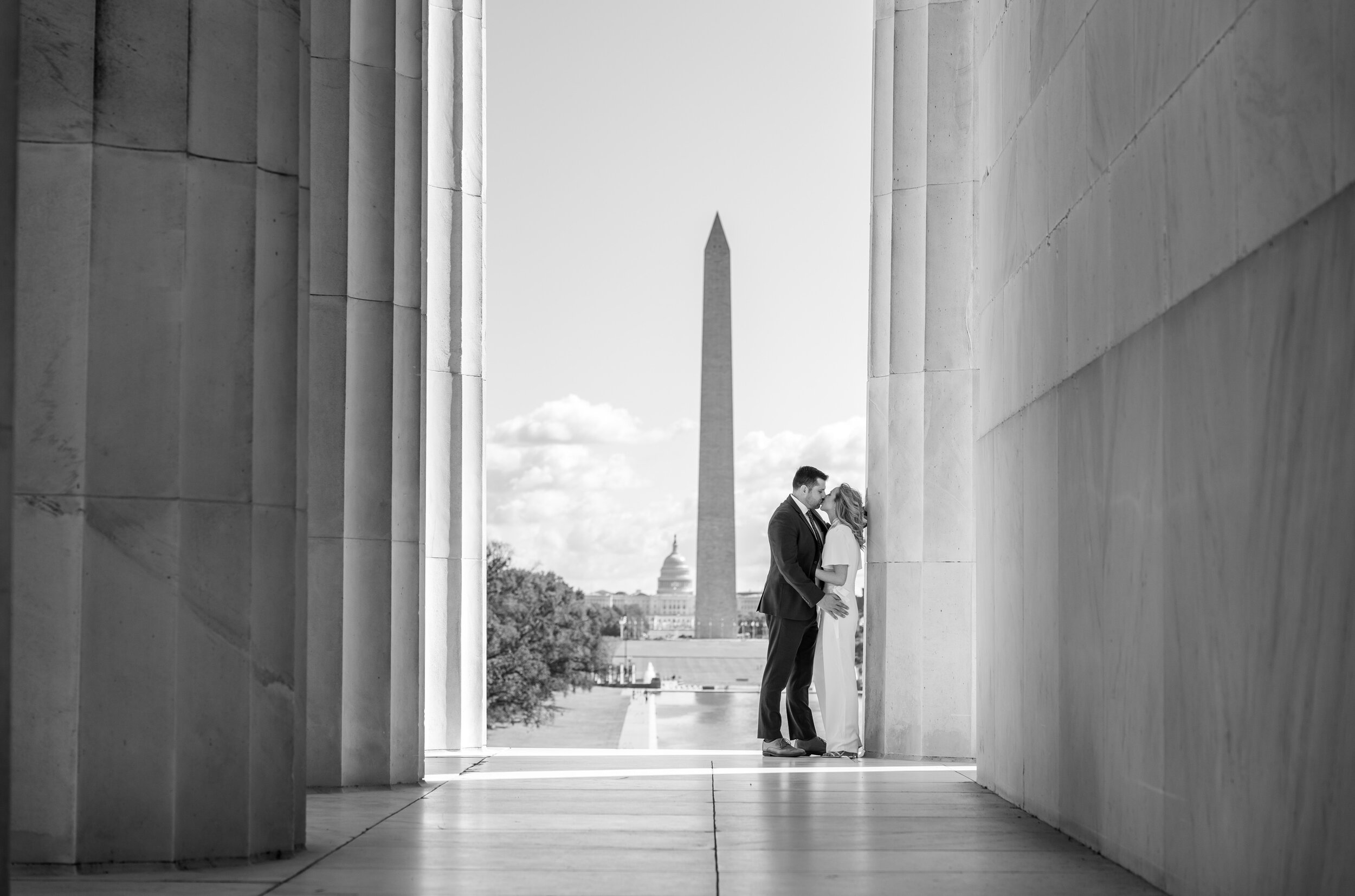 Black and white engagement photo at Lincoln Memorial with National Monument