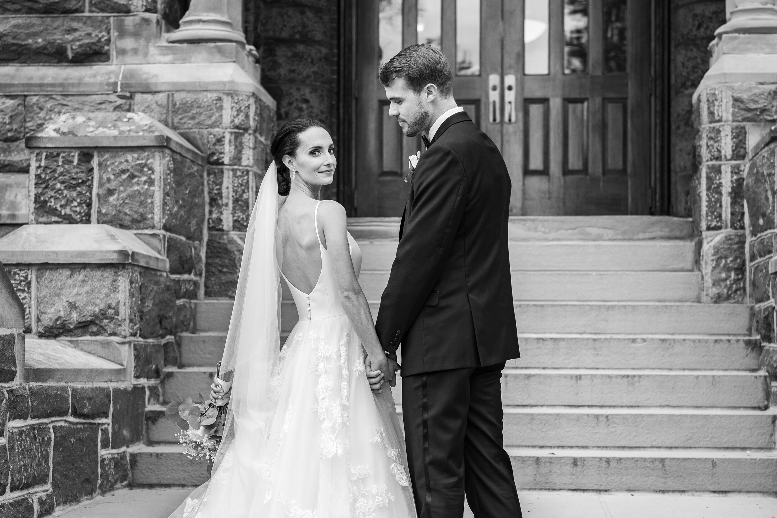 Bride and groom pose on steps at Georgetown University in DC
