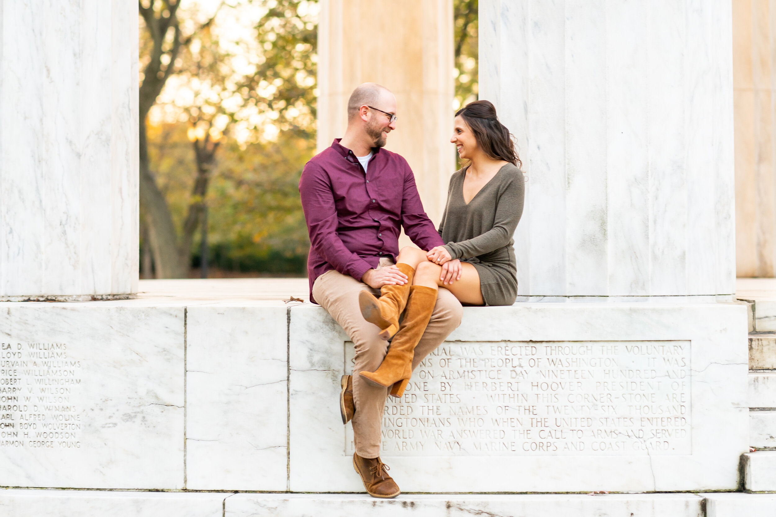 Couple sitting on the edge of the War Memorial in Washington DC