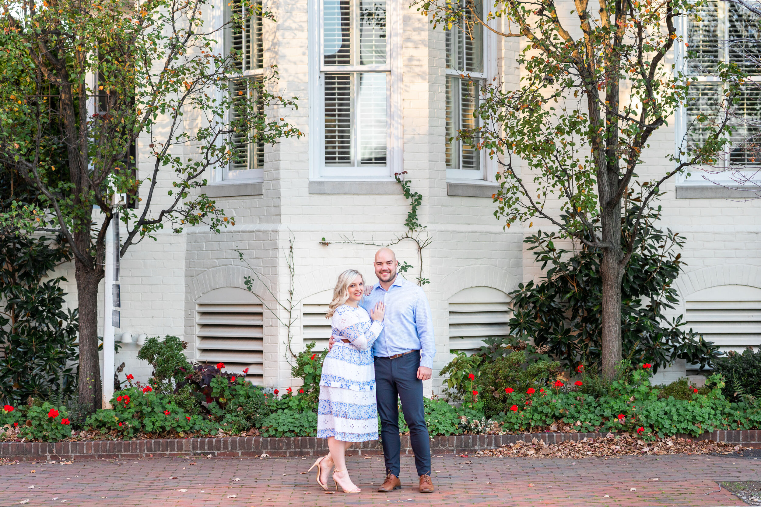 Bride and groom pose for engagement photos in Old Town Alexandria townhouses