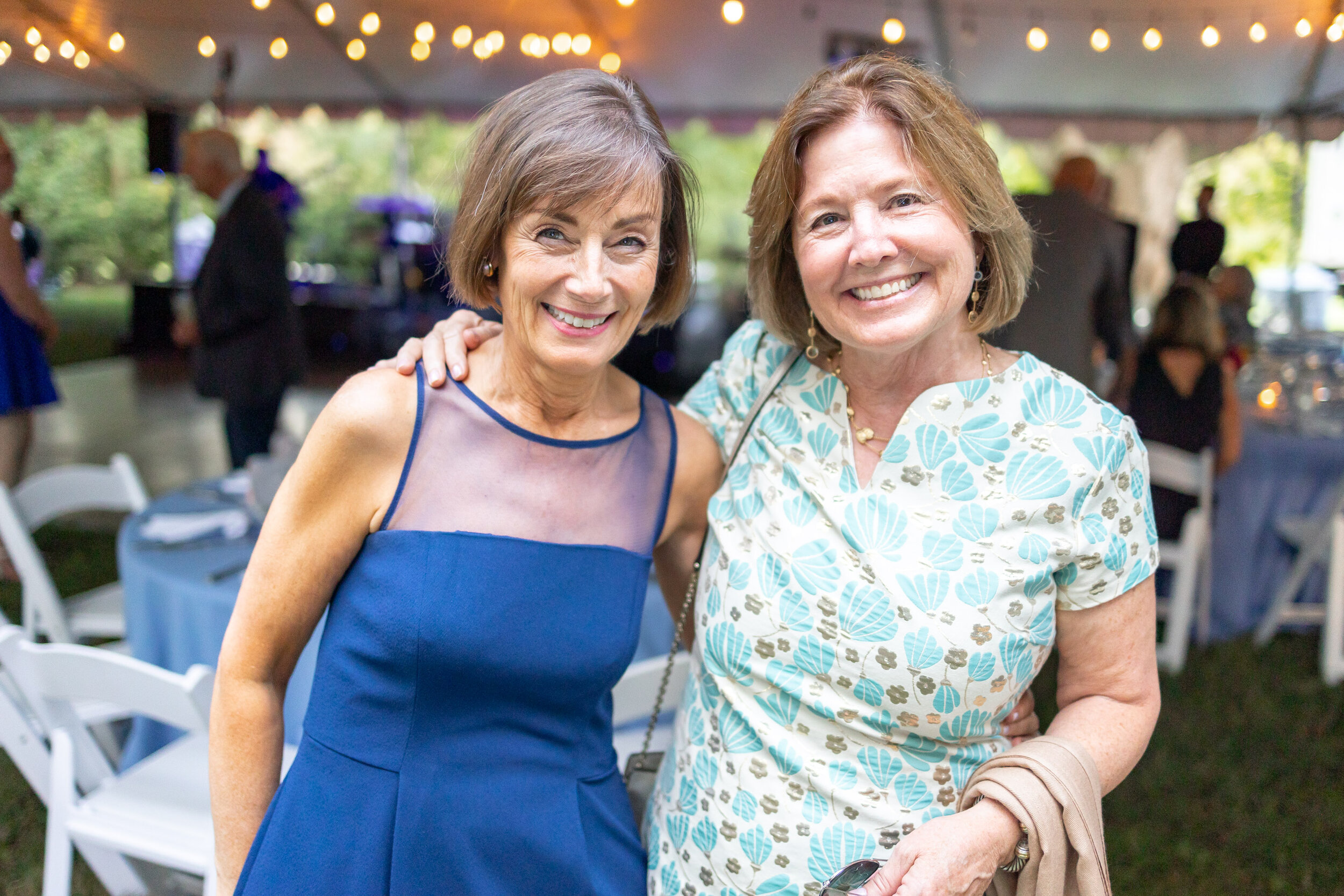 Mother of the groom and her friend smile during cocktail hour