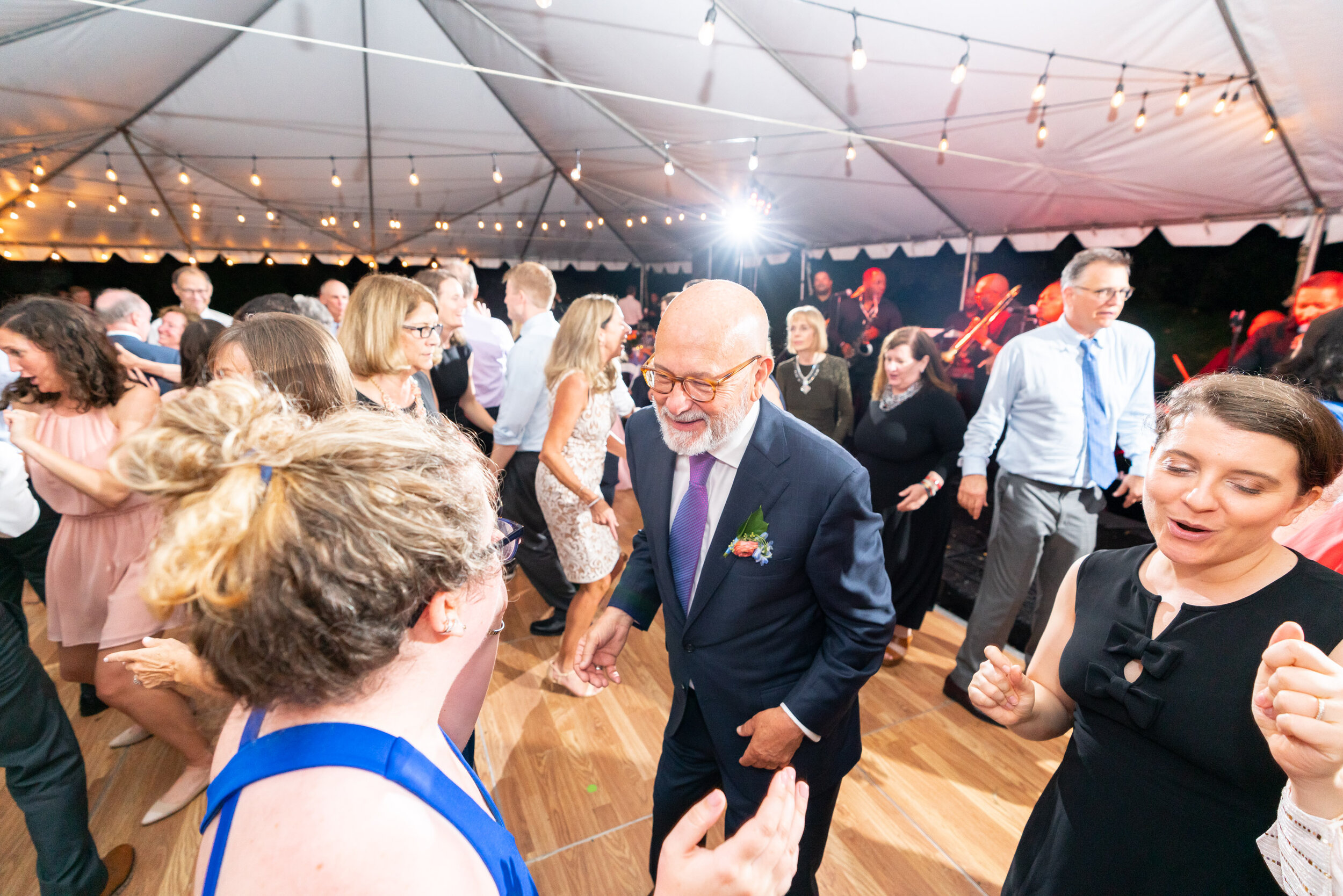 Grooms family dances under white tent at Glenview Mansion