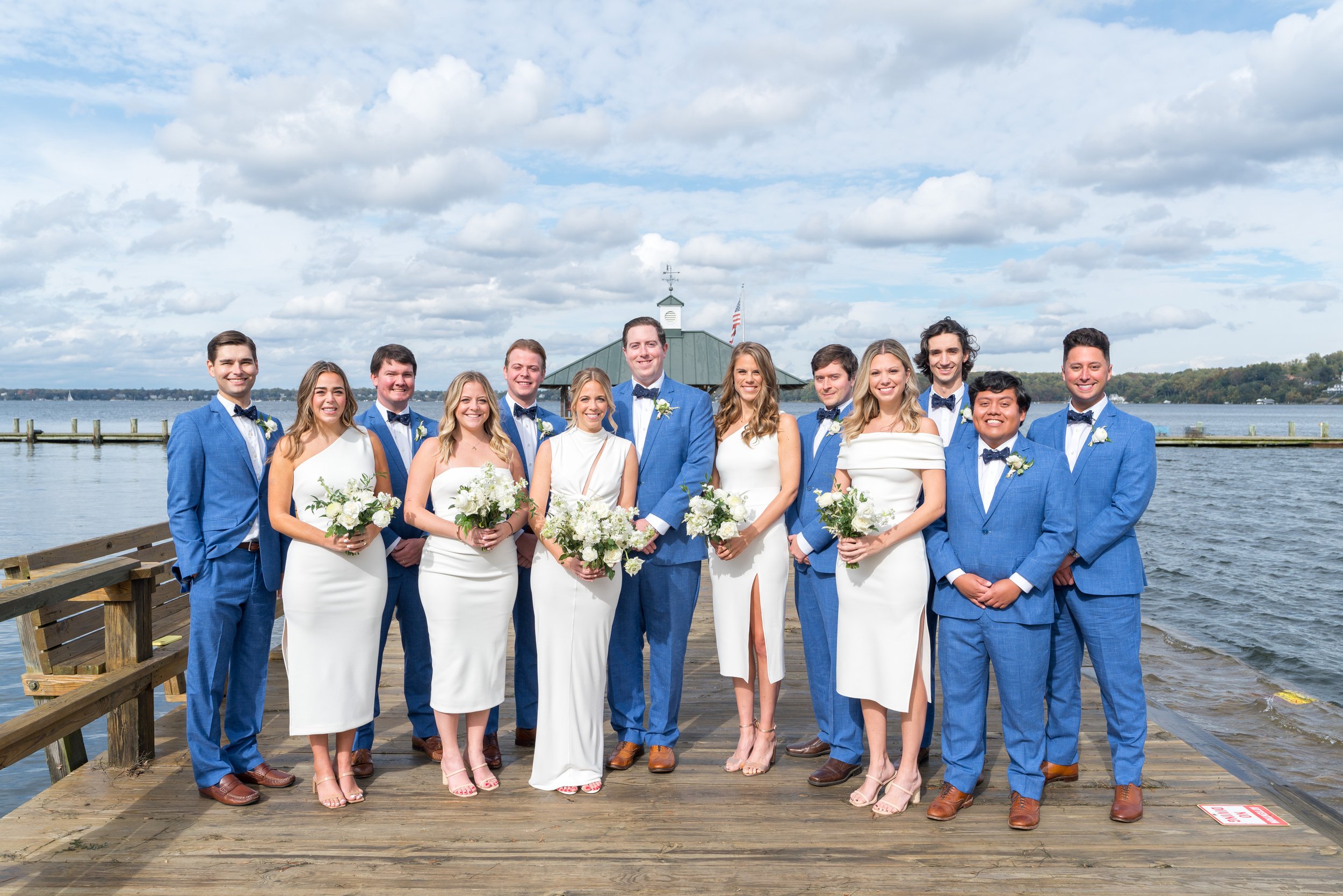 Bride and groom and wedding party in blue suits and white dresses