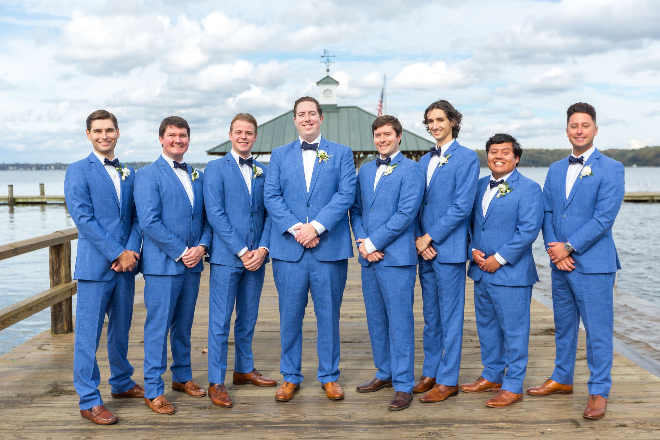 Groom and groomsmen in medium blue linen suits for summer wedding