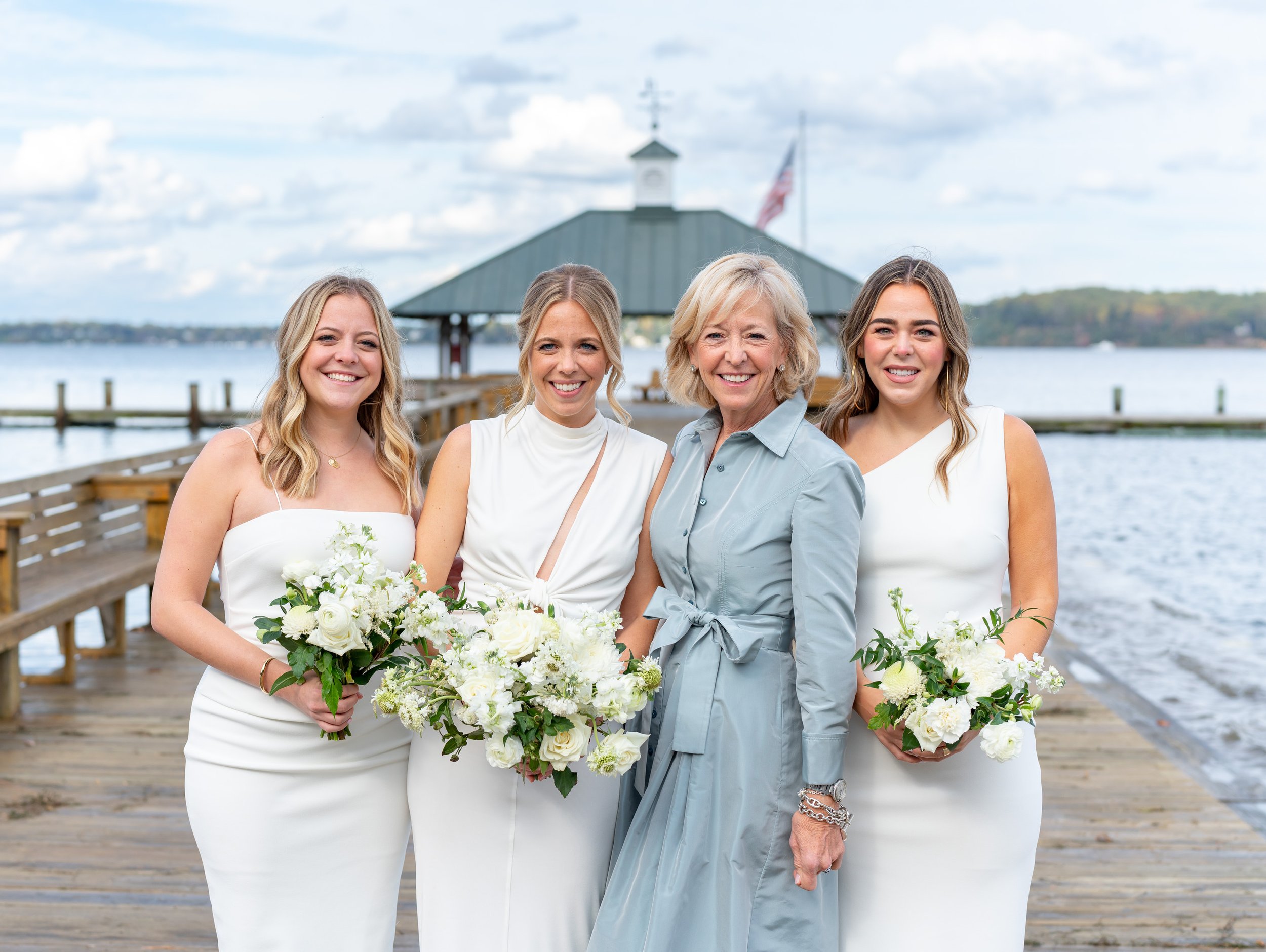 Bride and her mother and sisters pose on dock in Sherwood Forest MD