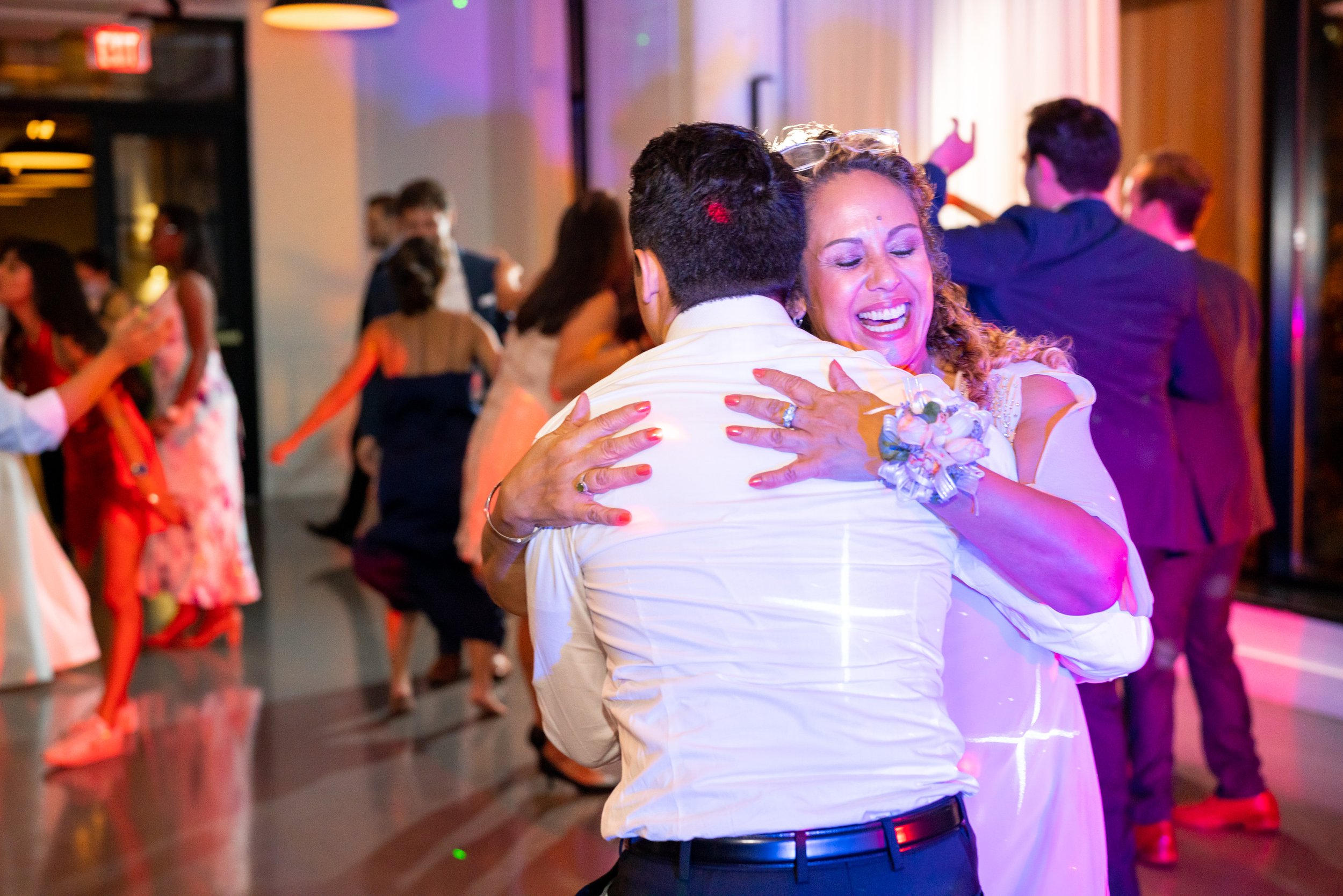 Groom hugs his mother on the dance floor at the end of the wedding