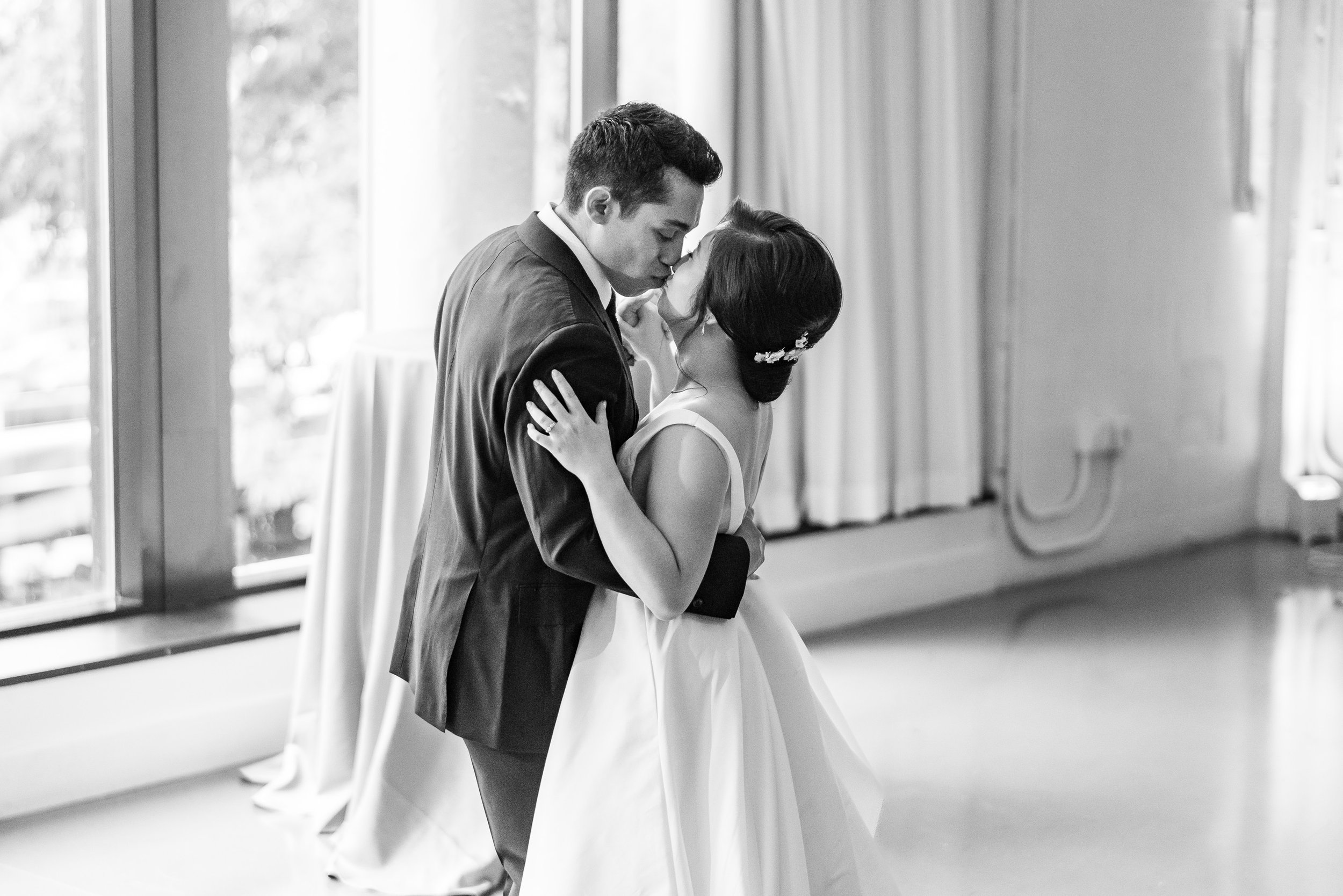 Bride and groom kiss during first dance on their wedding day
