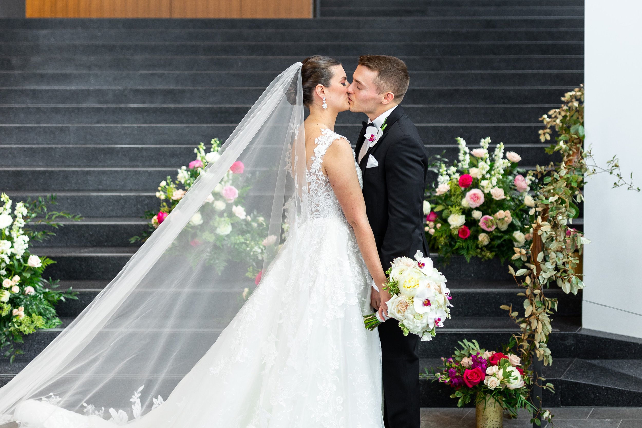 Bride and groom kiss during portraits at Capital One Hall wedding