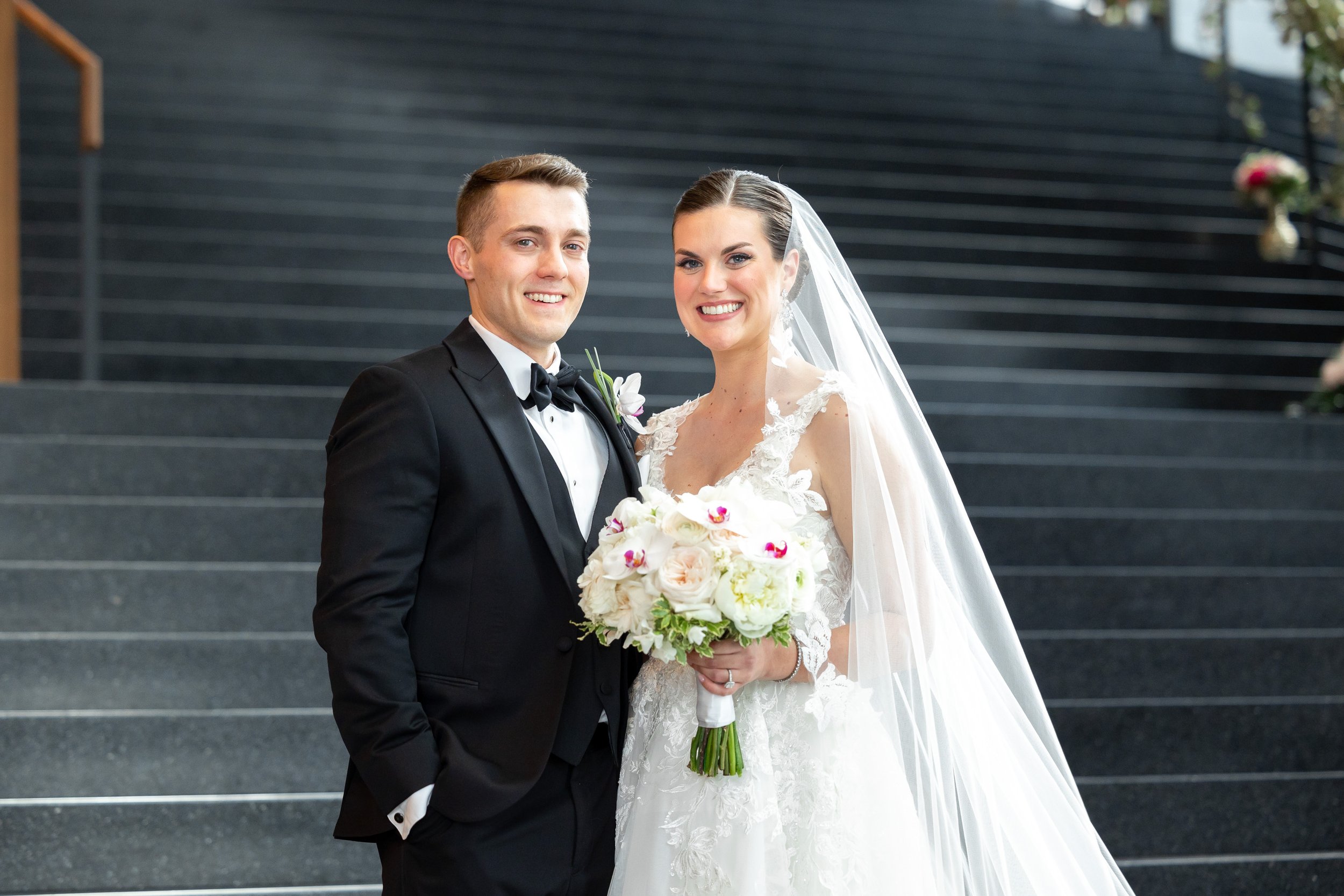 Bride and groom smile for romantic wedding portraits at Capital One Hall
