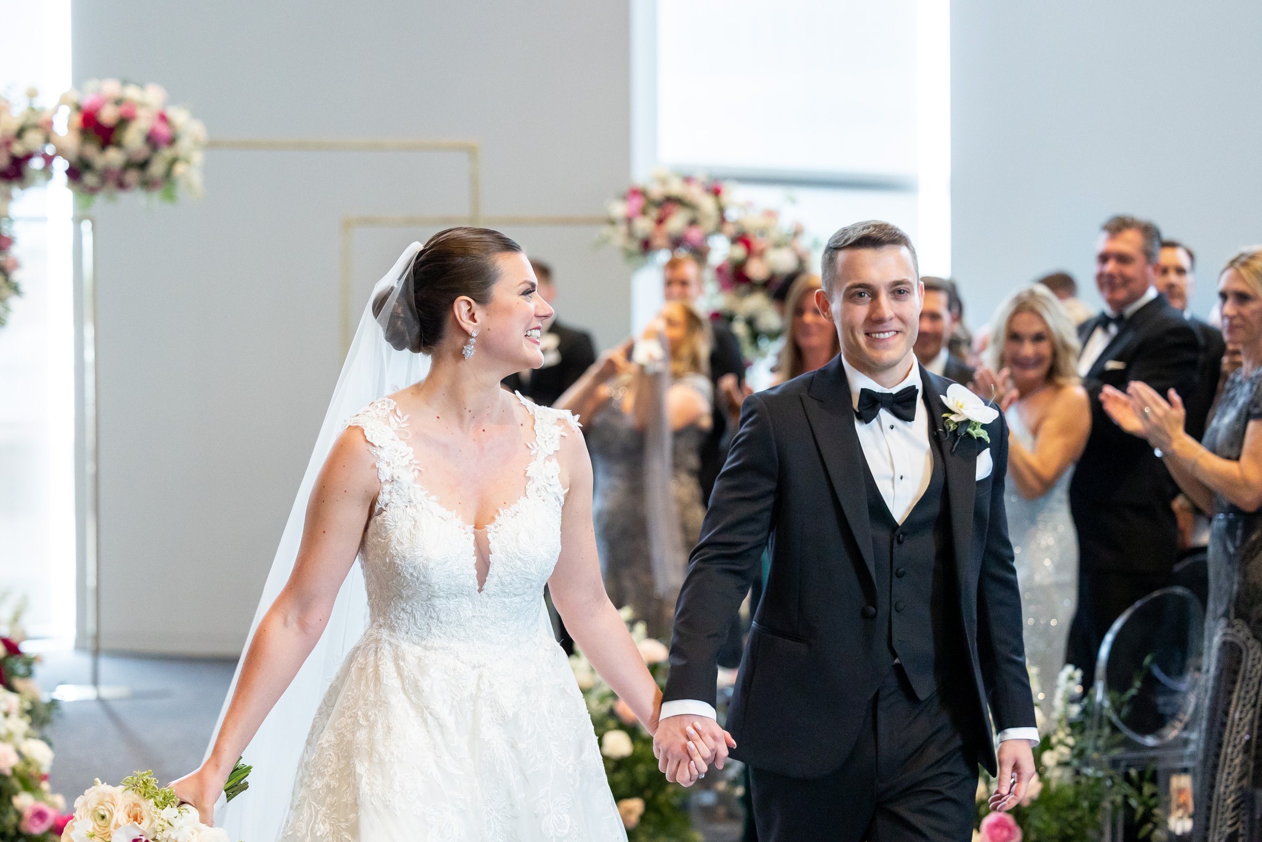 Bride and groom recess down the ceremony aisle at Capital One Hall wedding