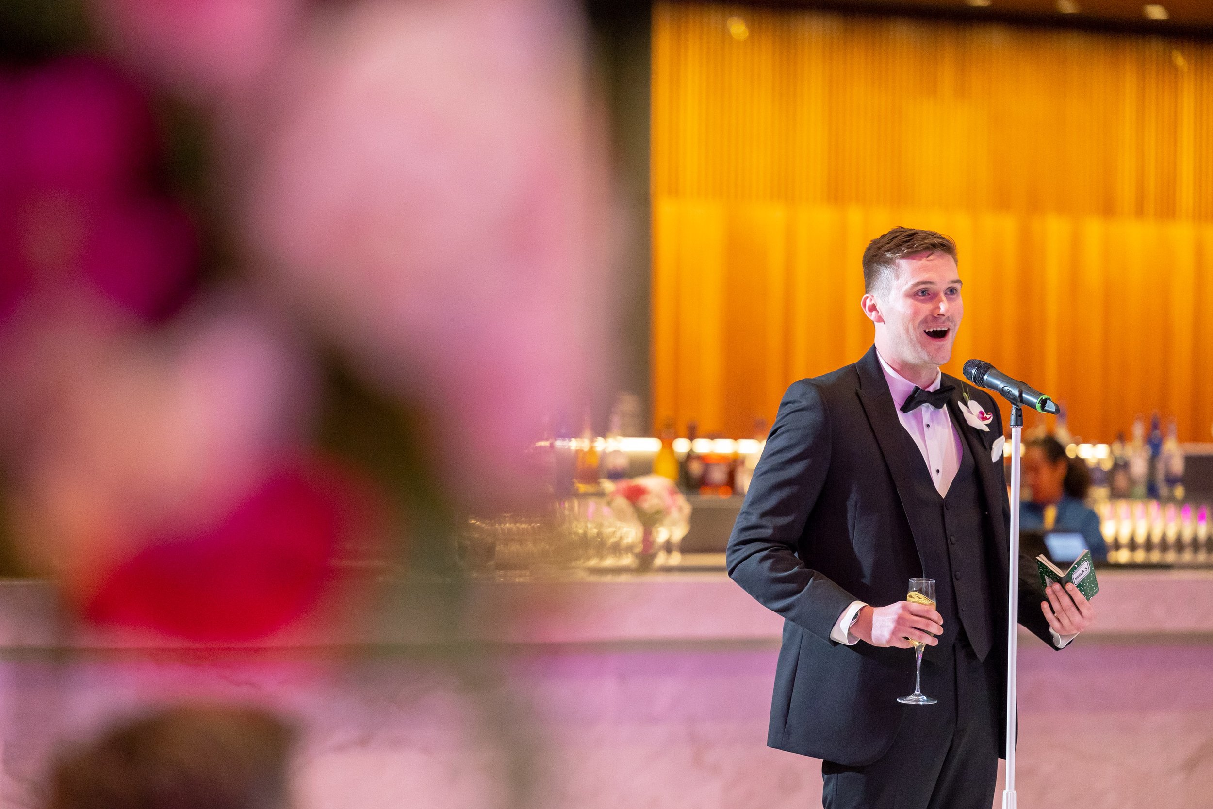 Best man gives toast speech during wedding reception at Capital One Hall