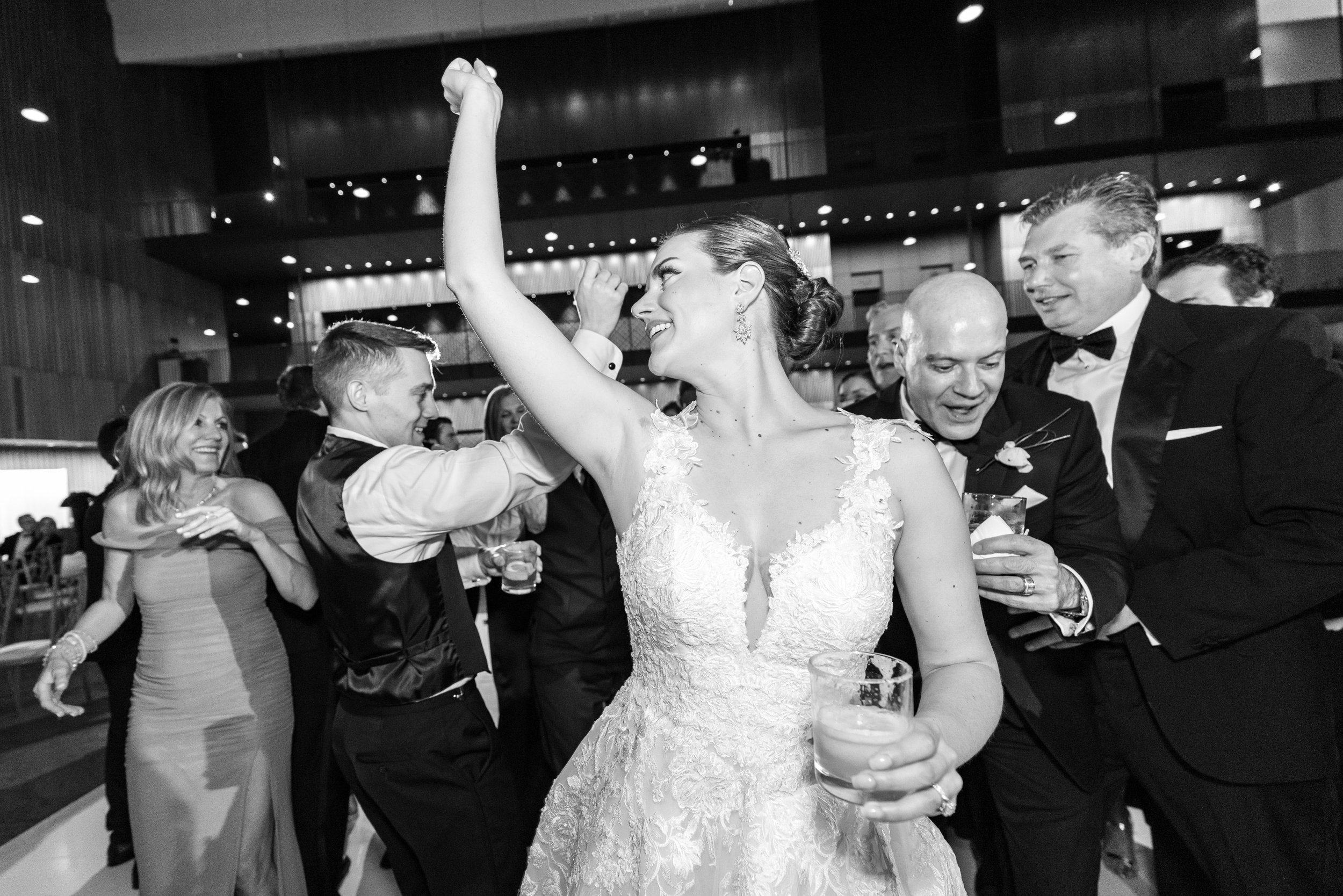 Black and white image of bride dancing at fun wedding reception photos