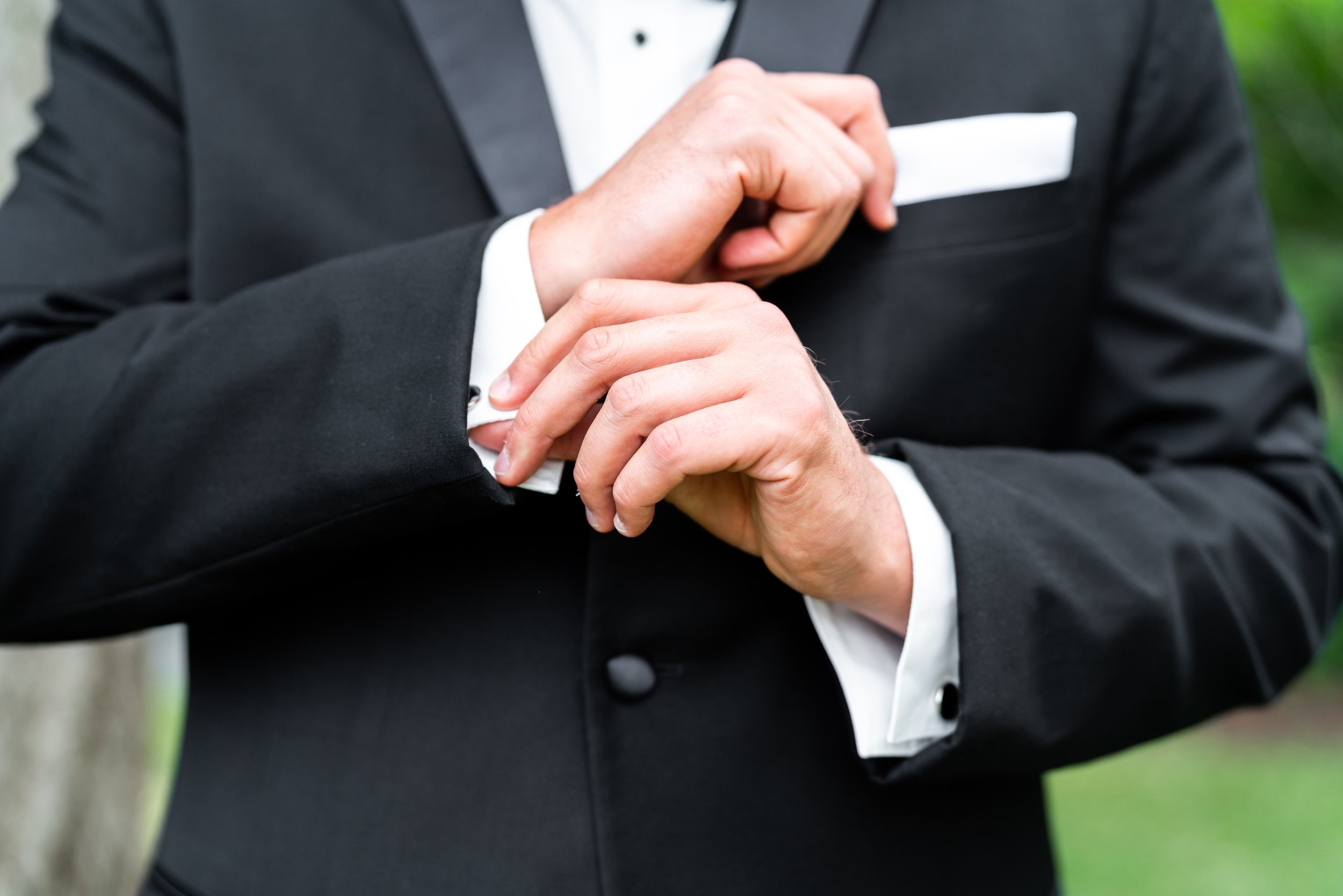 Groom adjusting his cuff links at fun DC wedding at President Lincolns Cottage 