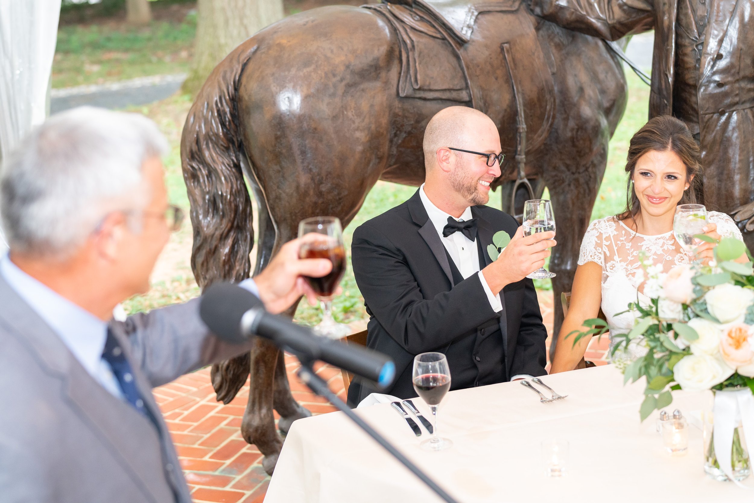 Bride, groom and father of the bride all toast during the speech