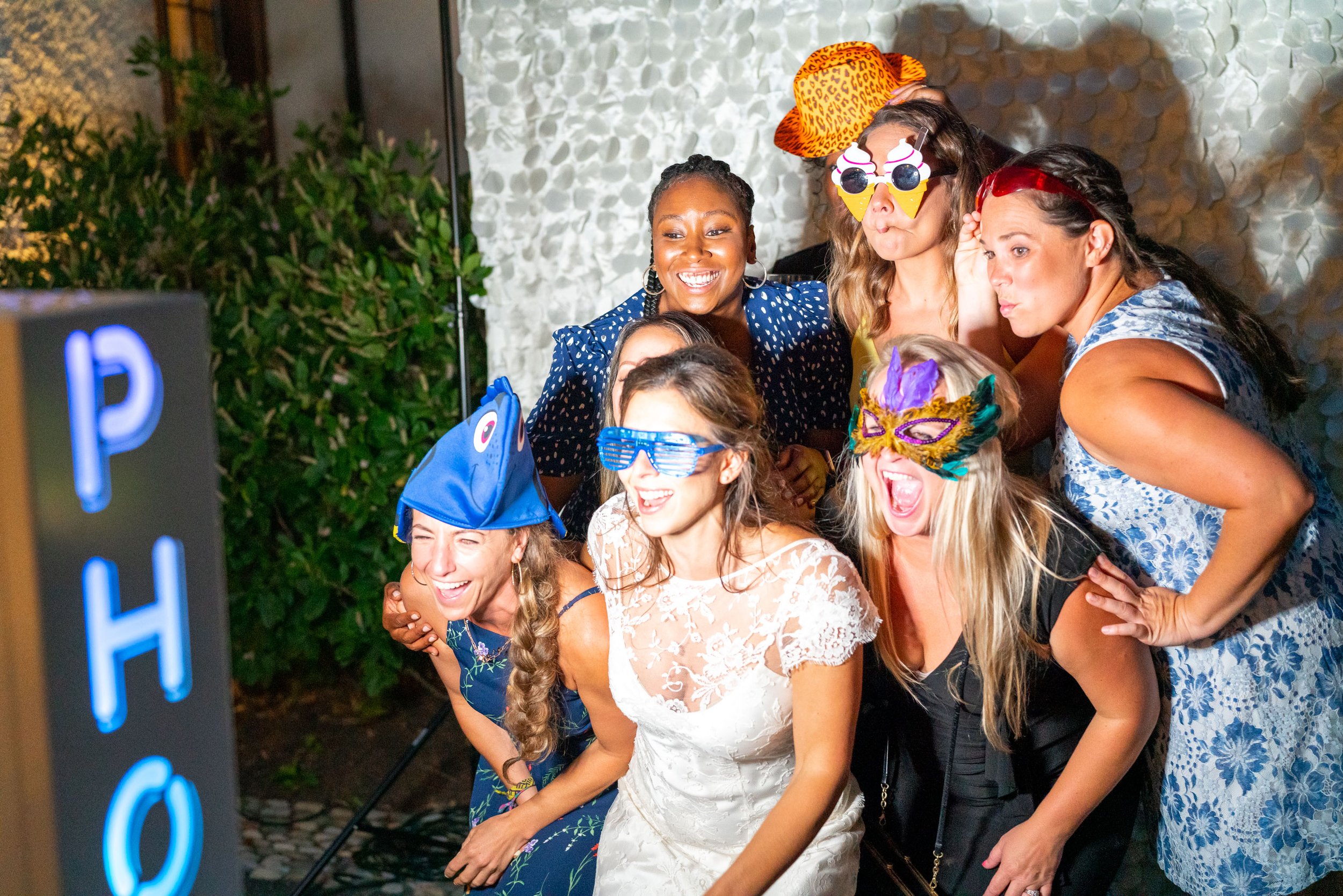 Bride and her friends posing at the Photo Booth in sunglasses