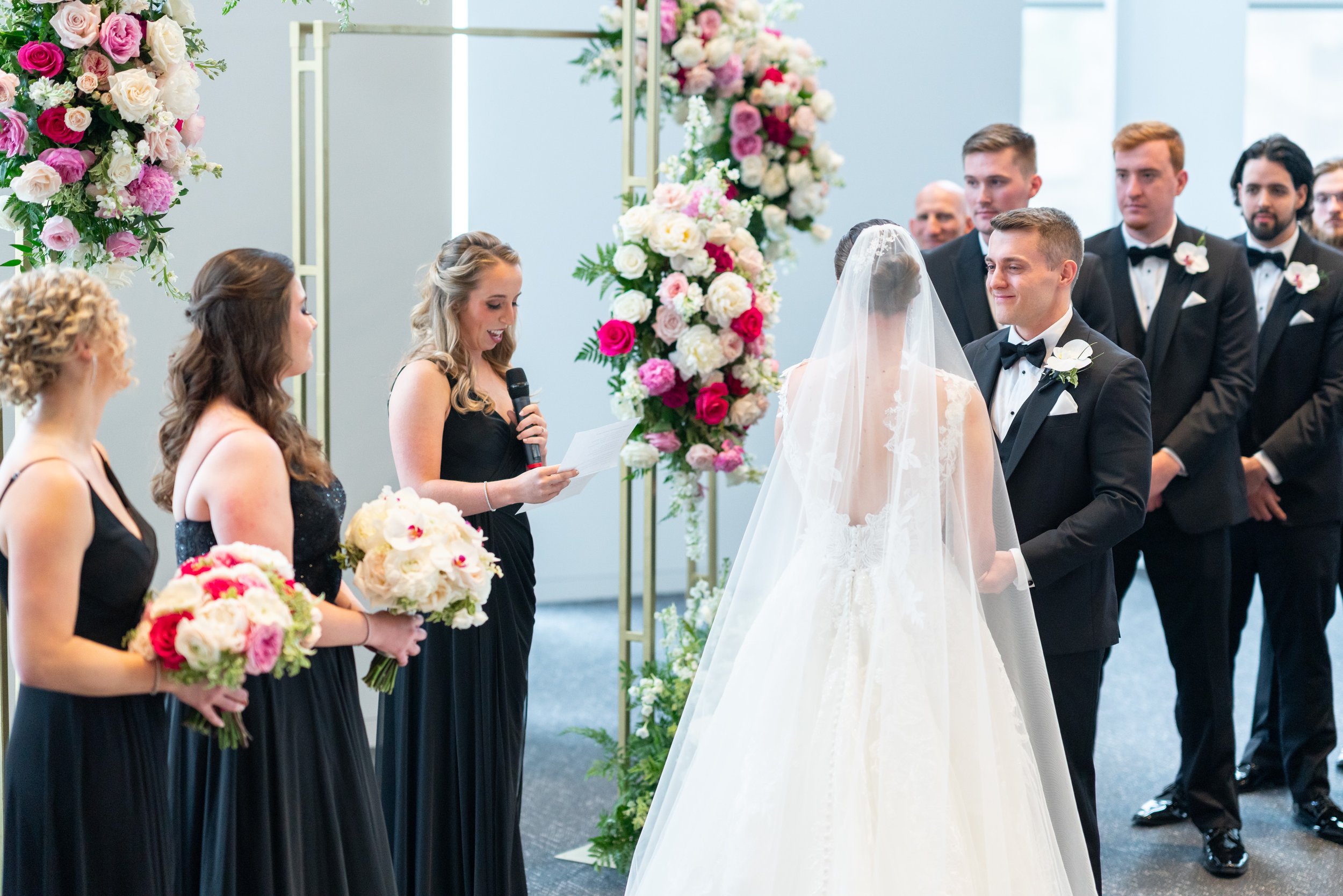 Bridesmaid giving toast during wedding ceremony at Capital One Hall