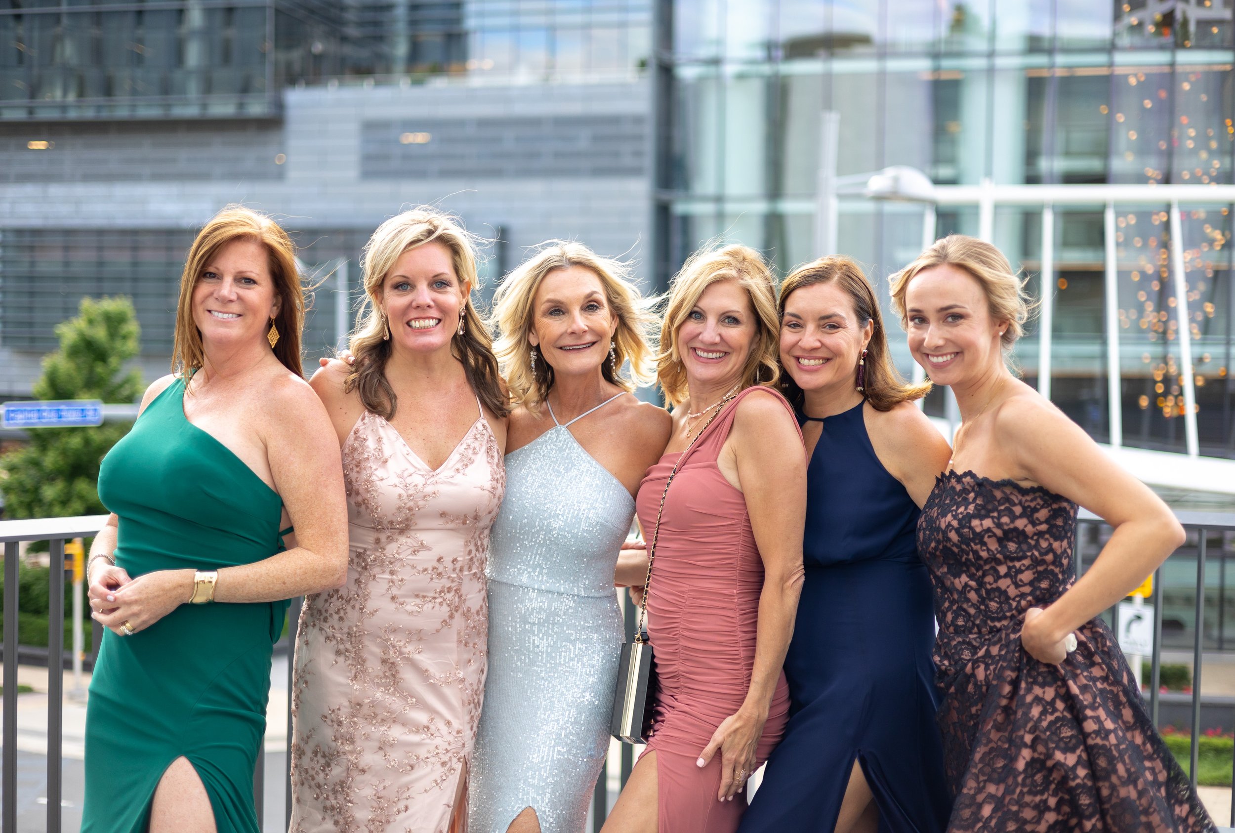 Beautiful women posing in gowns on balcony in Tyson's Corner wedding photos