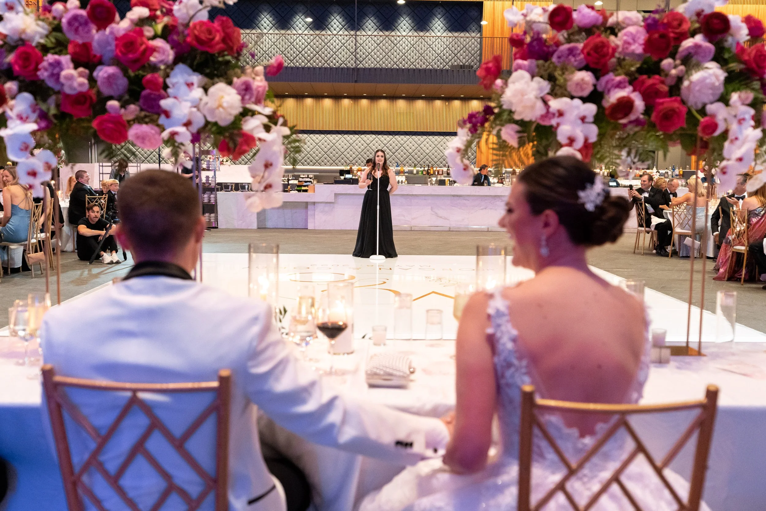 Maid of Honor gives wedding speech in black Azazie bridesmaid dress