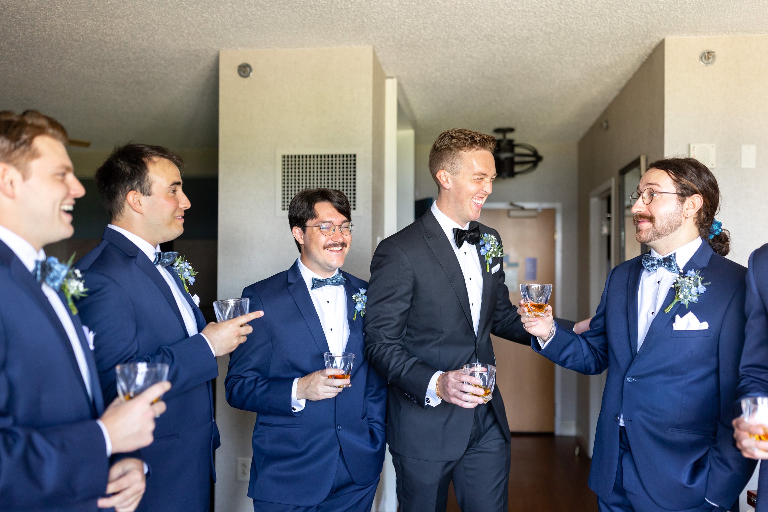 Groom toasts groomsmen in blue suits at Hyatt Regency Chesapeake wedding