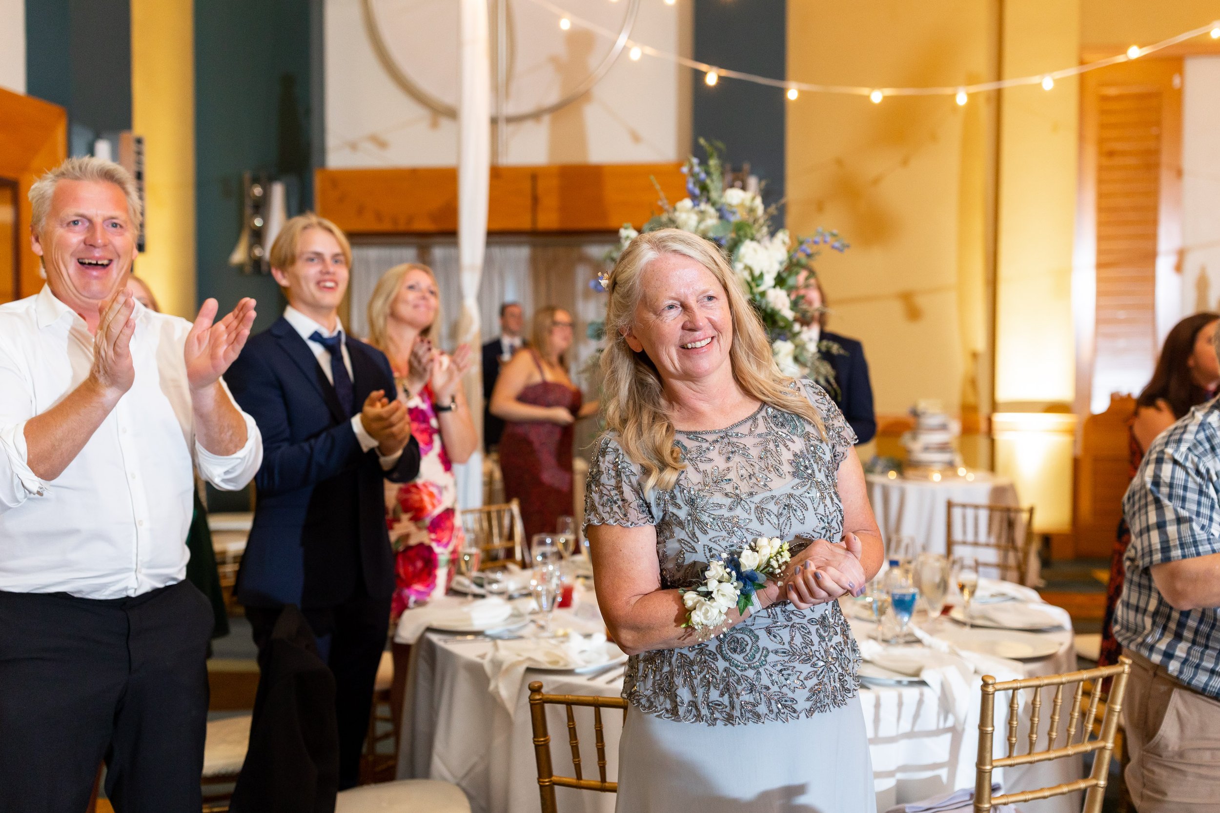 Mother of the groom watches first dance during fun wedding