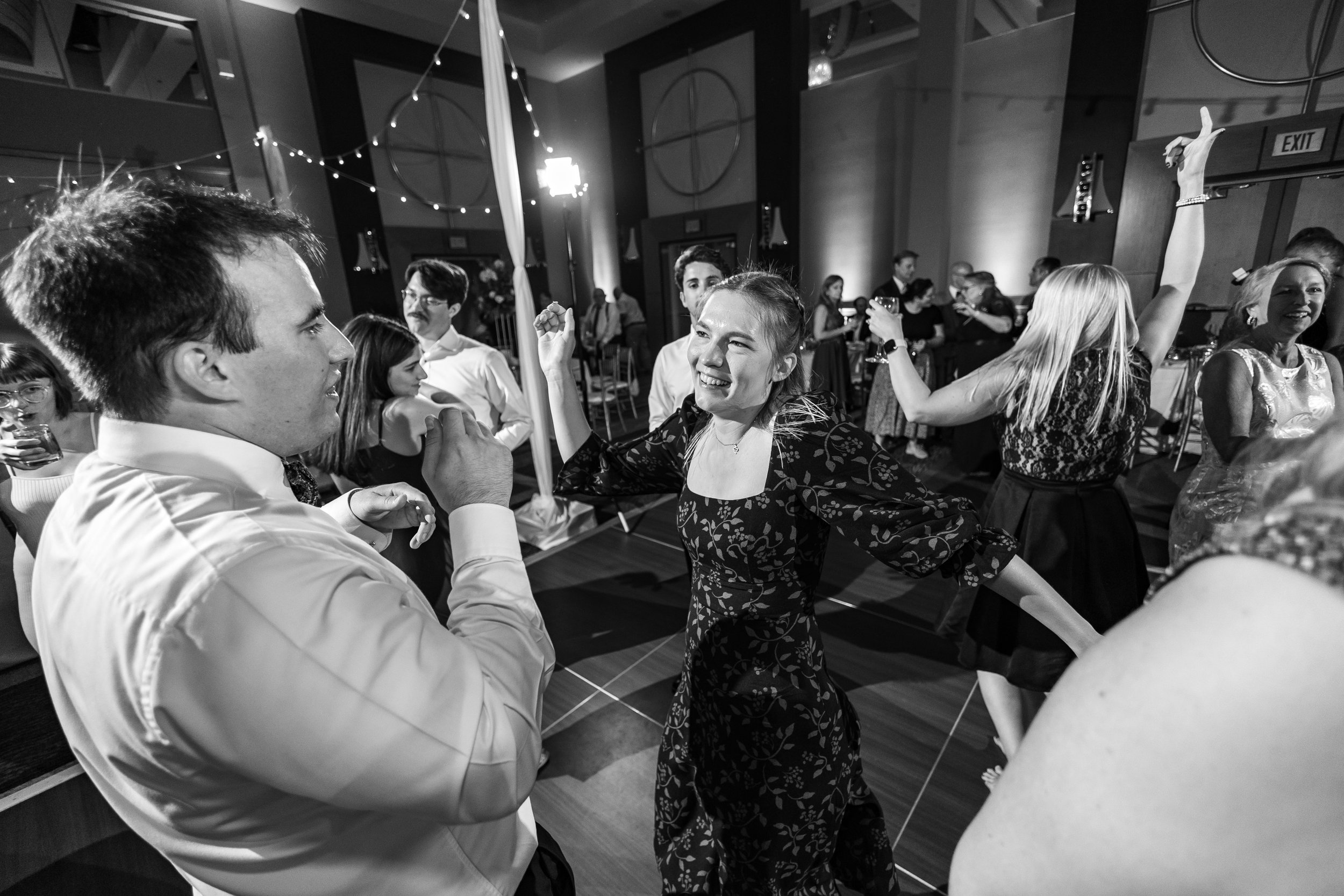 Candid wedding photos of guests laughing and dancing in Annapolis MD