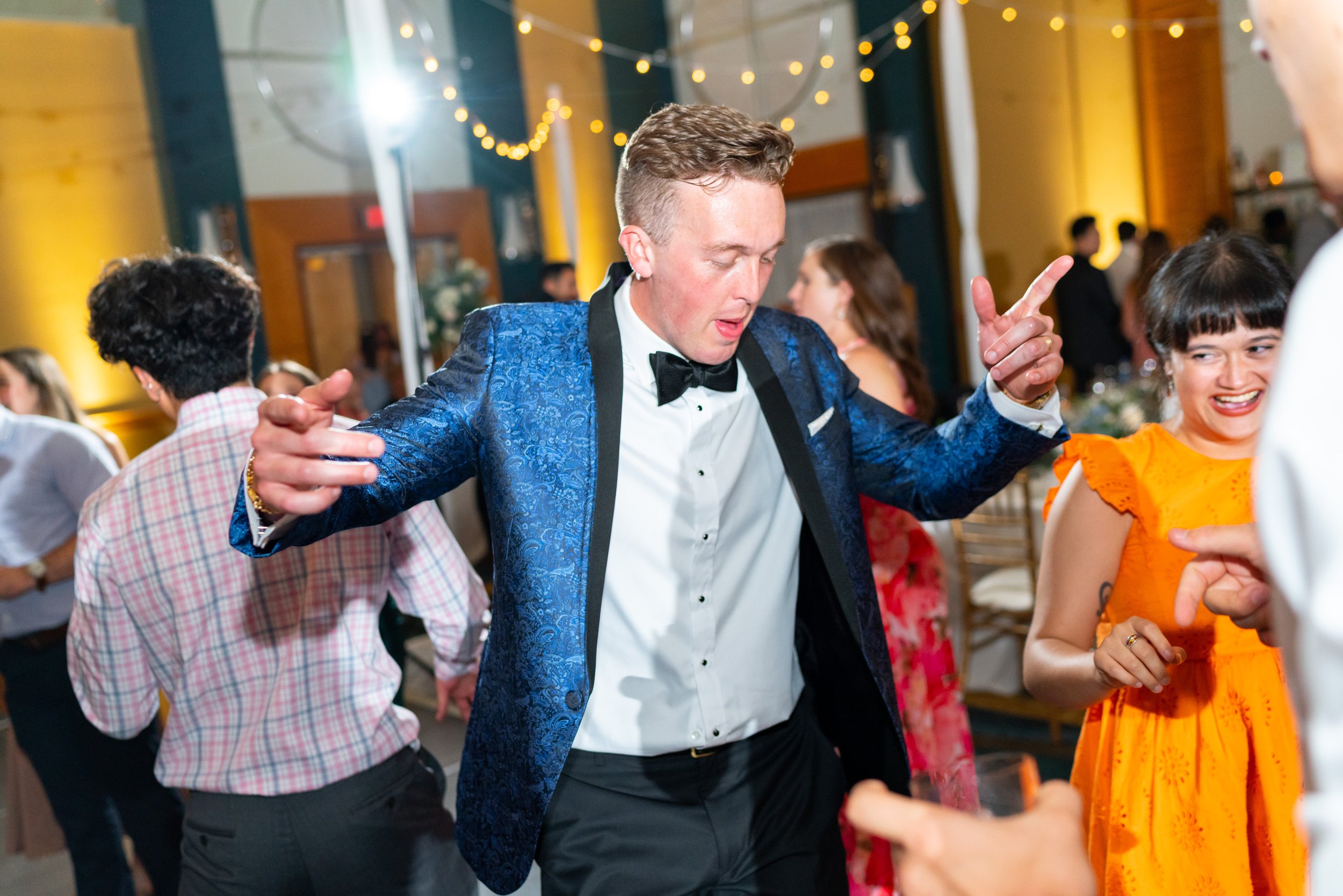 fun and colorful wedding photos of guests on the dance floor
