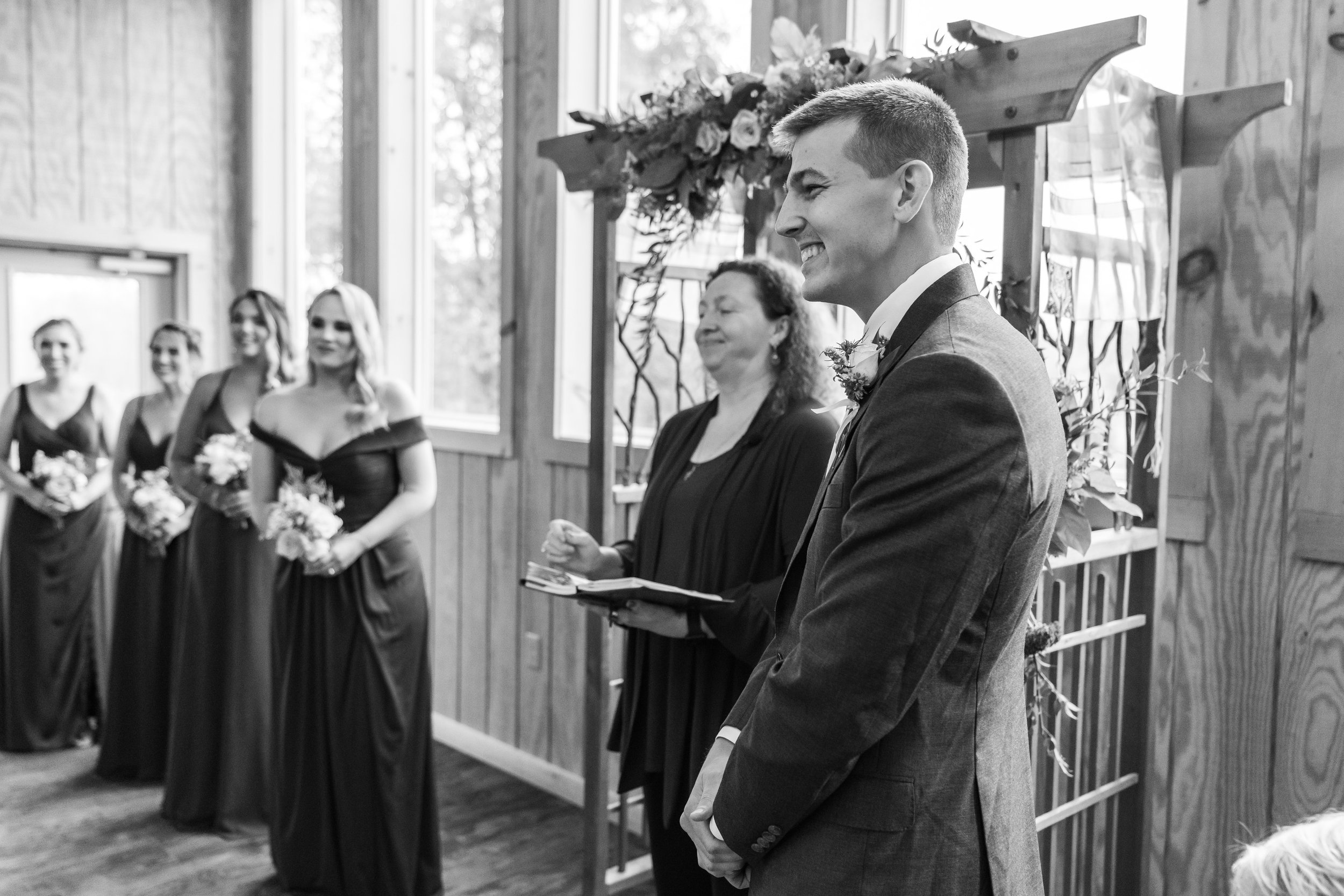 Groom watches bride walking down the aisle at Stover Hall ceremony