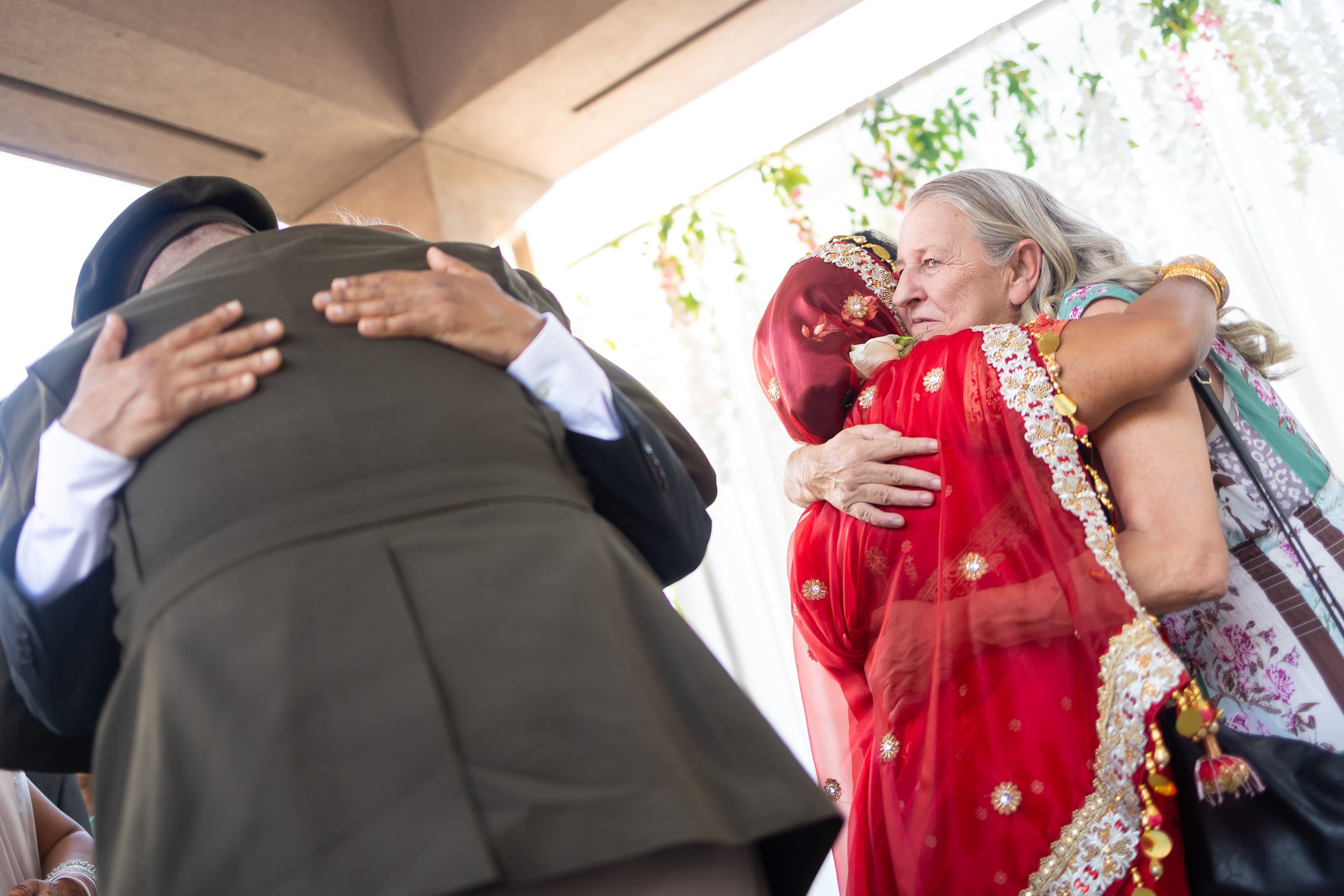 Bride and groom hug their parents after the wedding ceremony