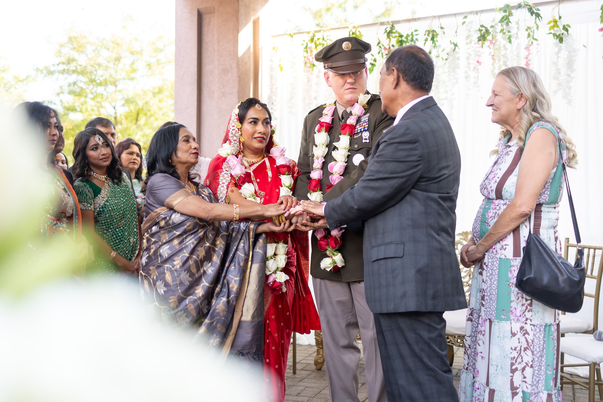 Bride and groom and parents join hands during nikkah at Hyatt regency Dulles wedding