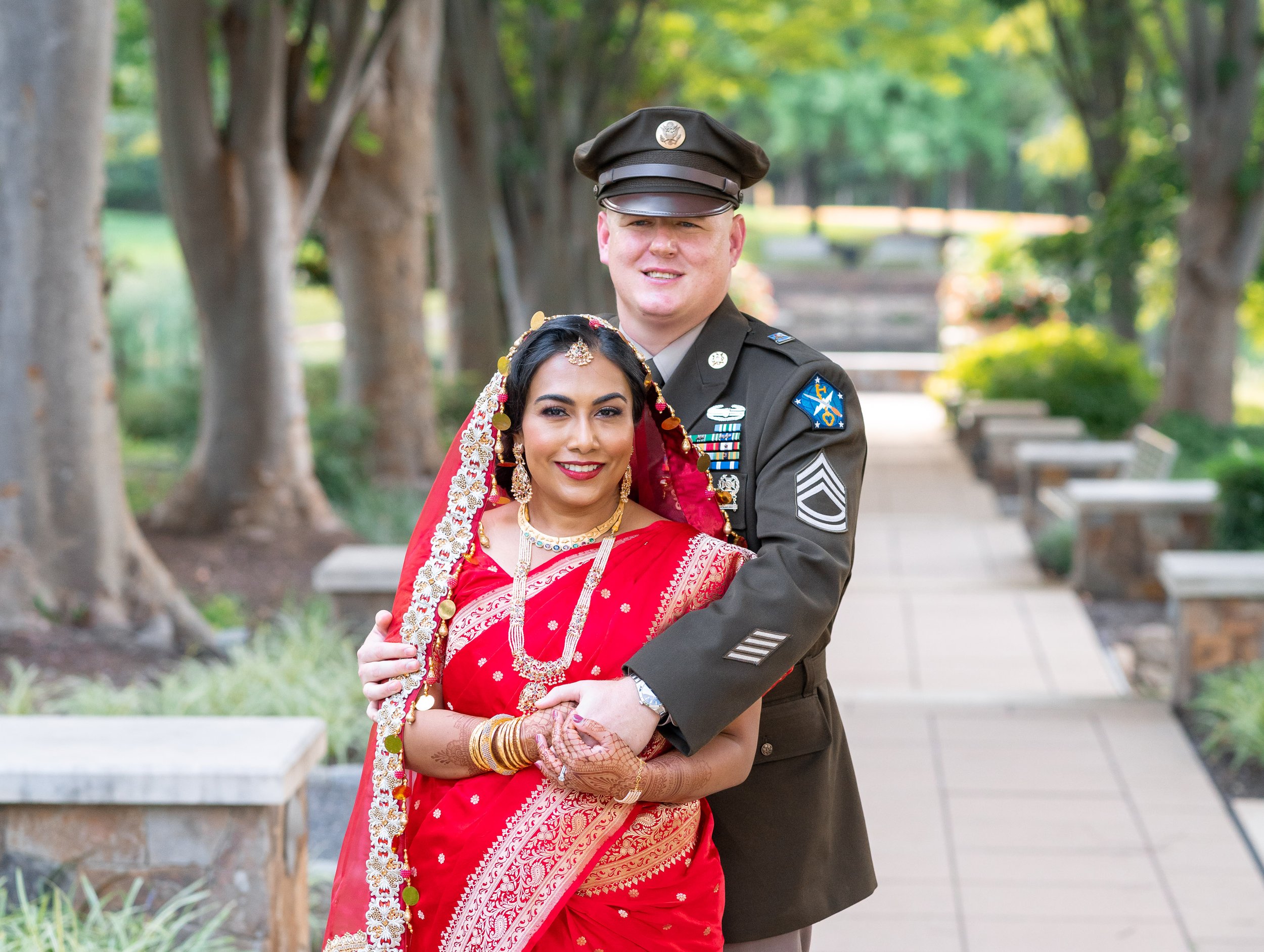 Army groom and Indian muslim bride hug for wedding portraits at Hyatt regency Dulles