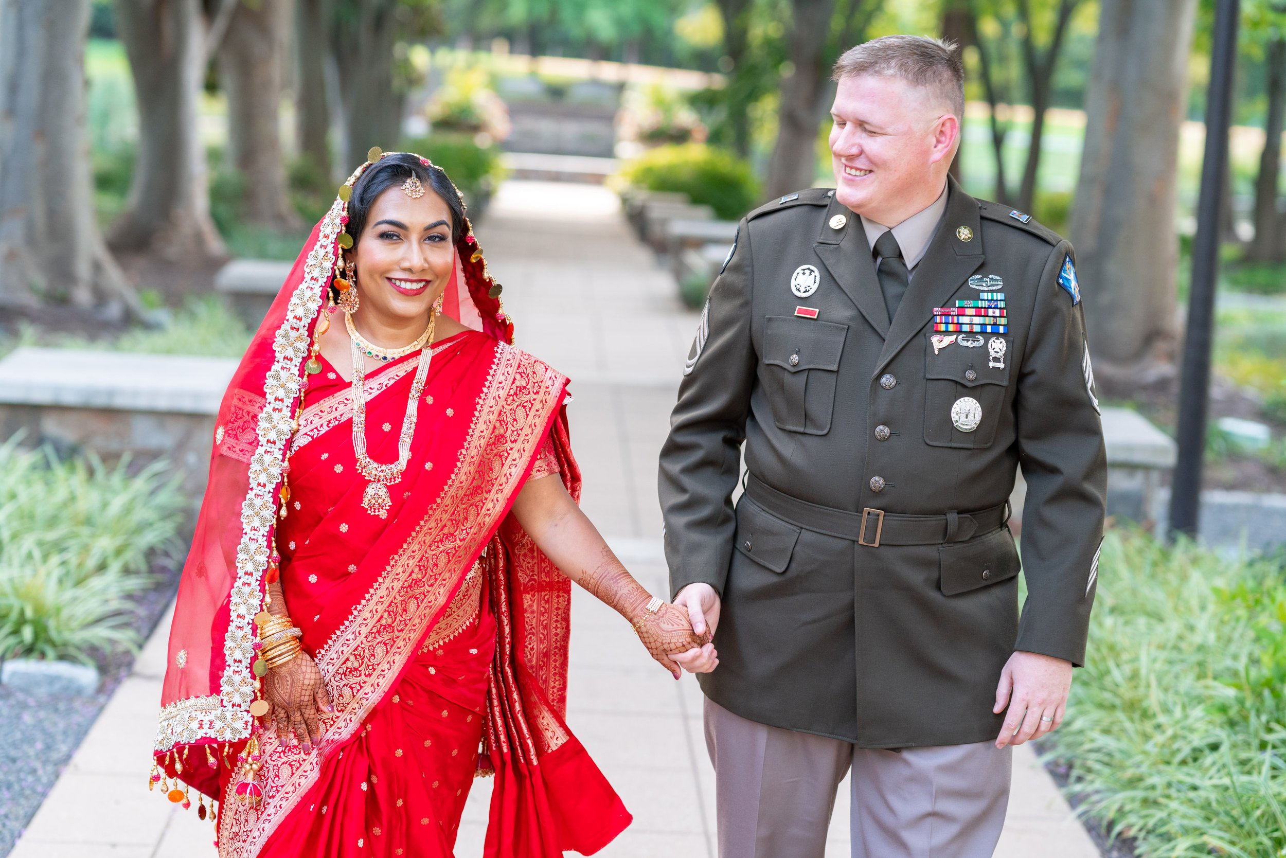 Muslim Indian bride and army groom walk hand in hand at Dulles park
