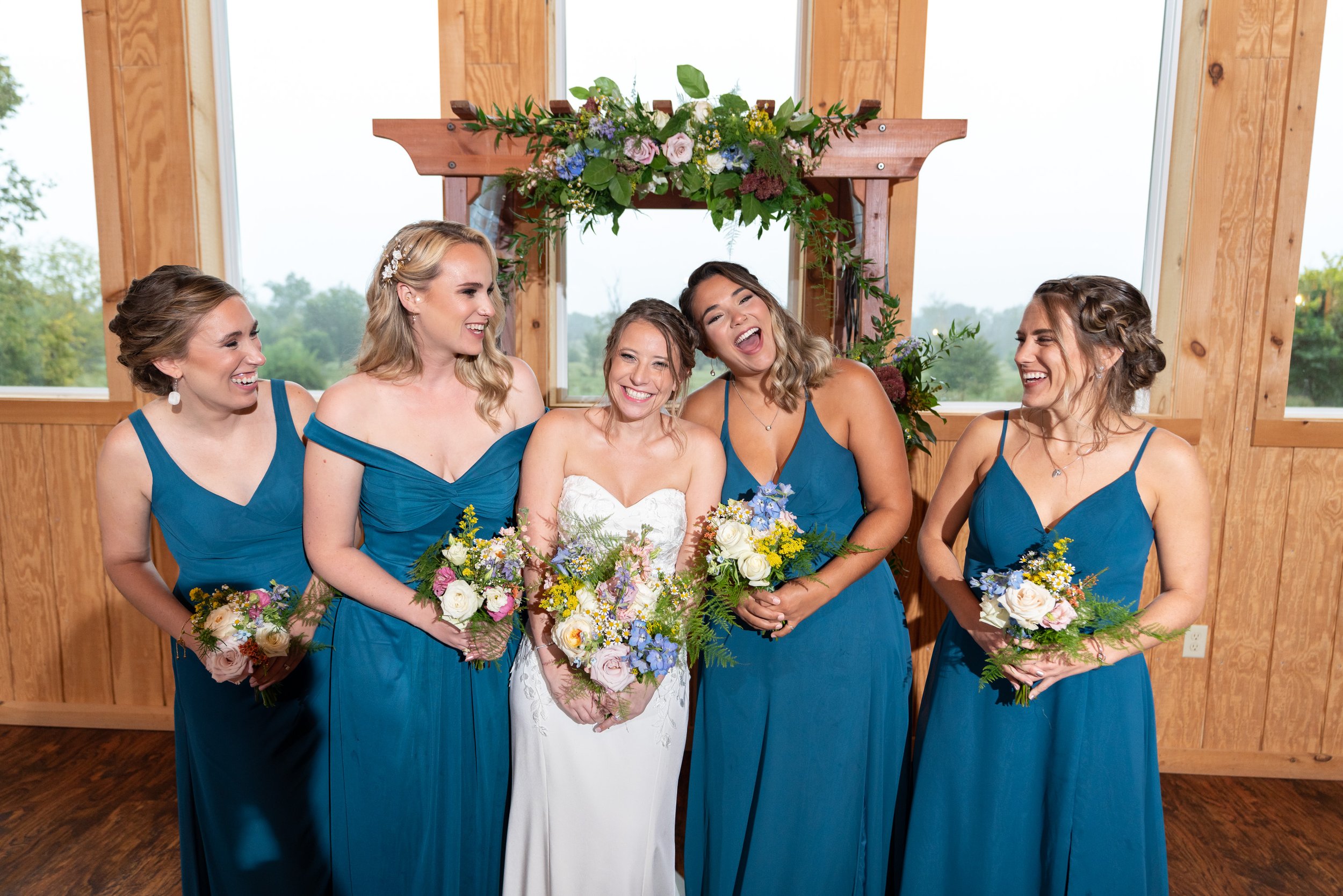 Bride and bridesmaids in ink blue azazie gowns