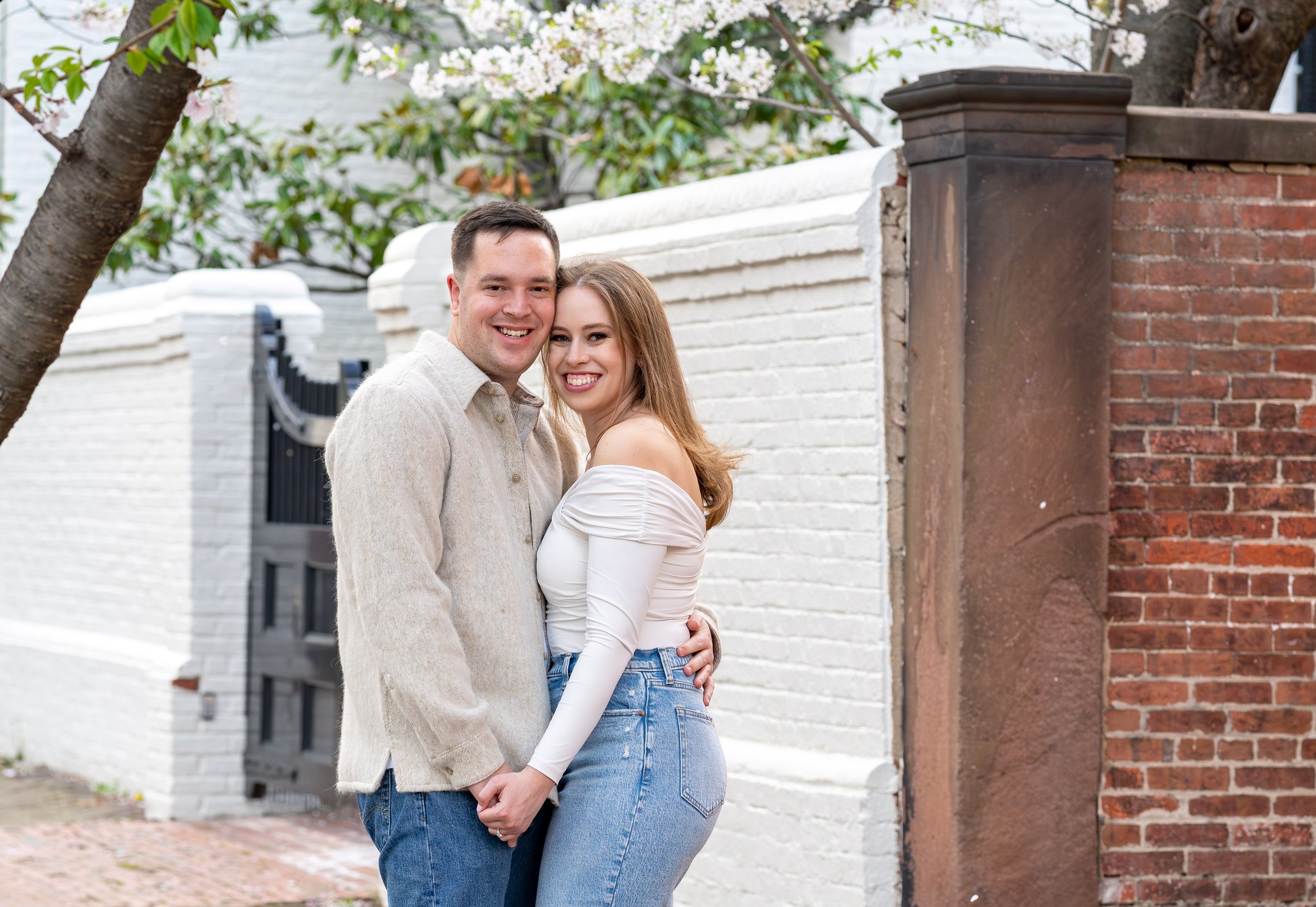 Couple pose in cherry blossoms in Alexandria virginia