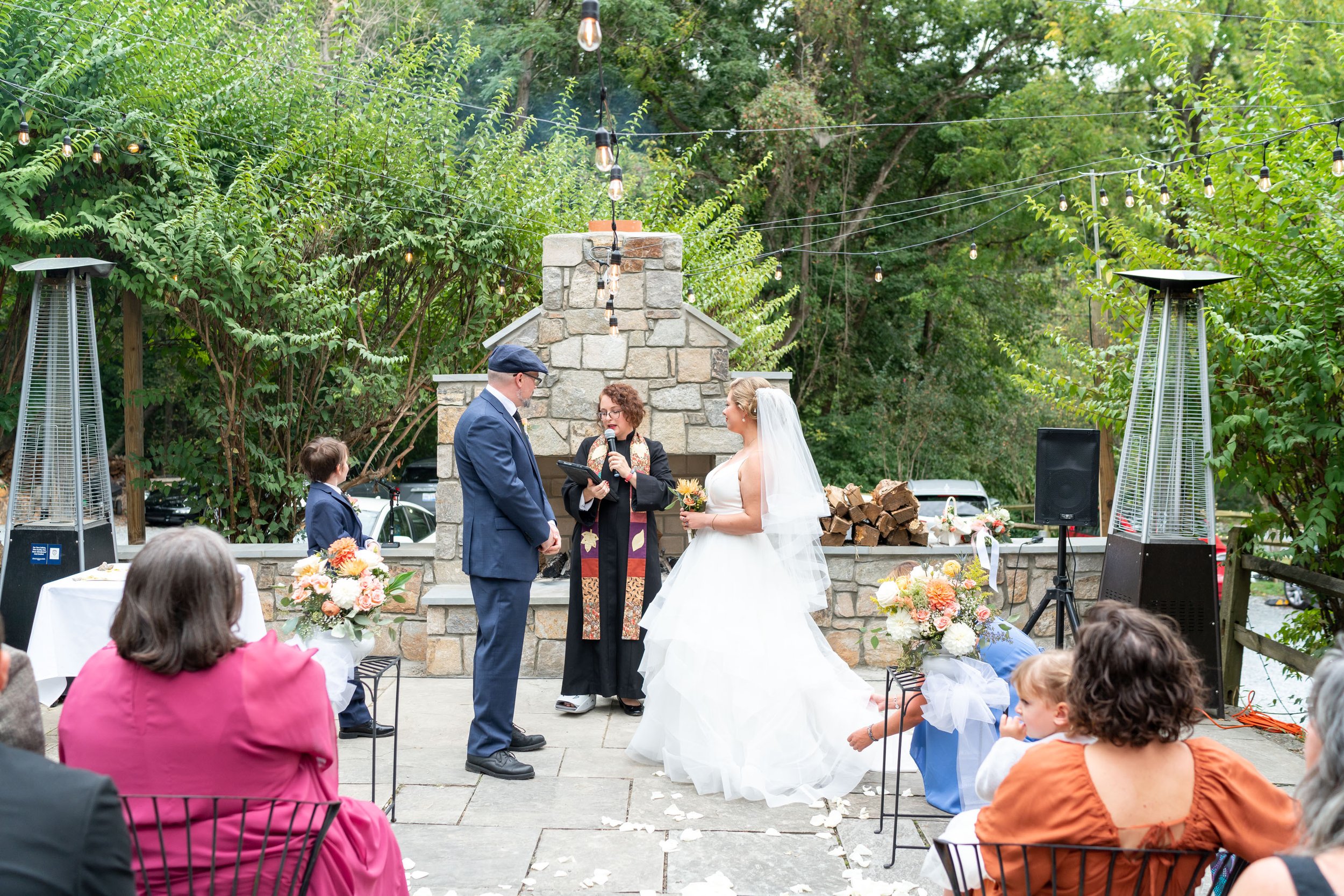 Ceremony on the terrace with fireplace at Old Angler's Inn