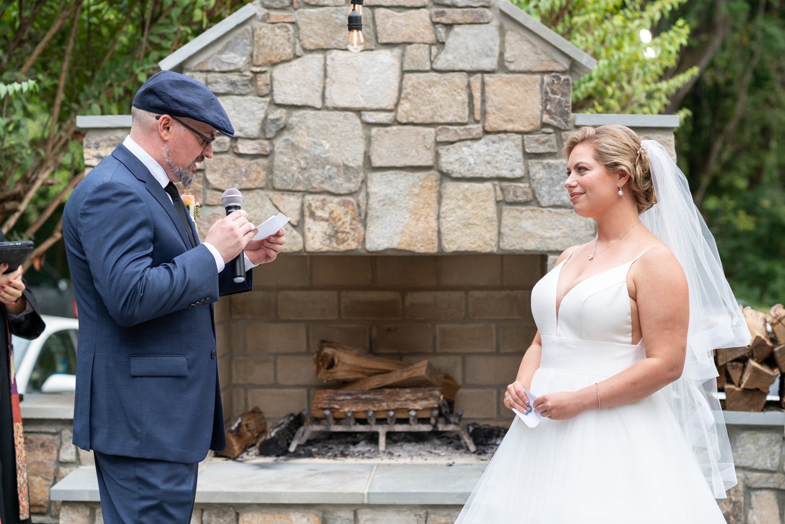Groom reads his vows on terrace at Old Angler's Inn wedding